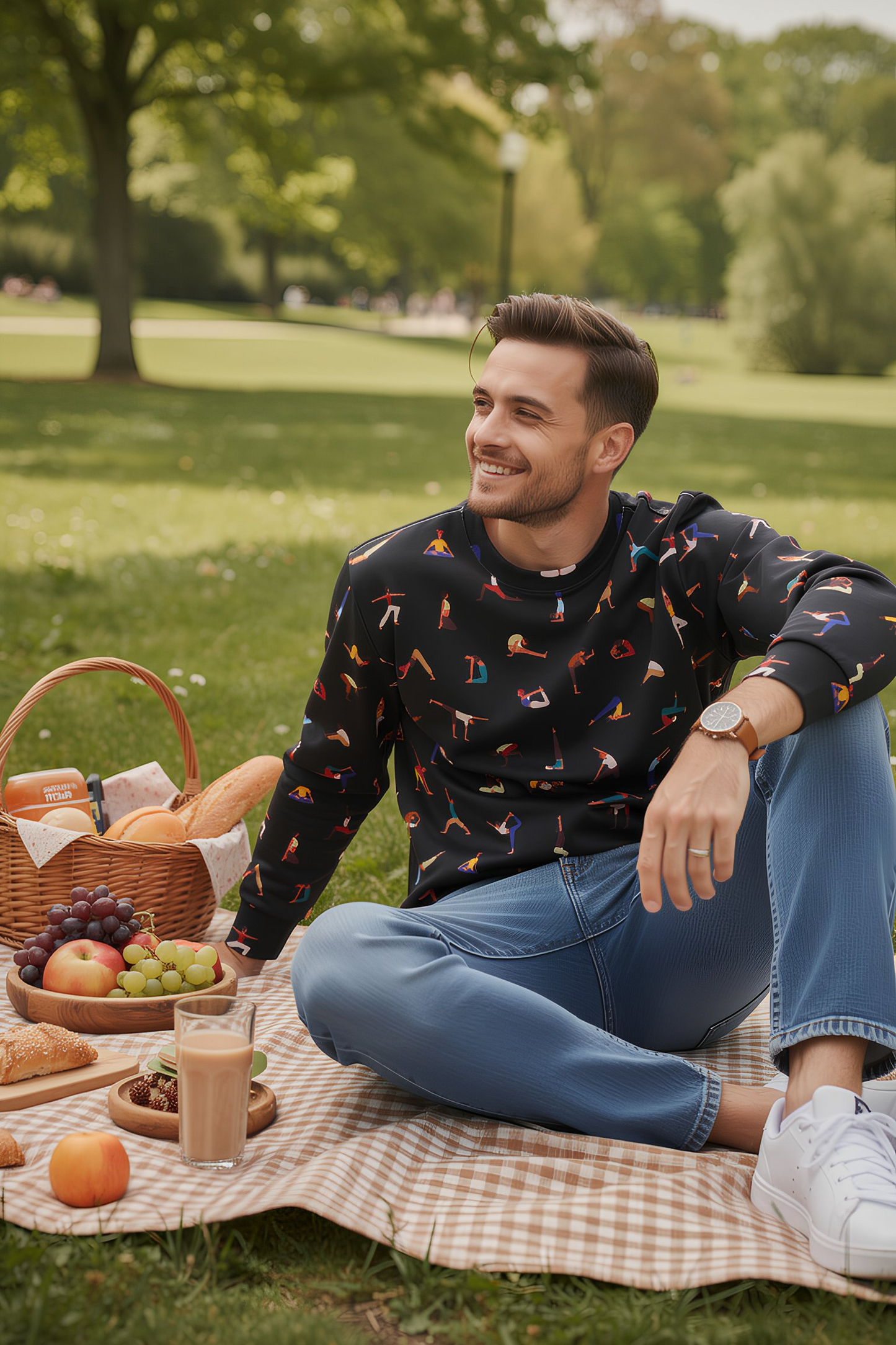 Man sitting on picnic blanket wearing Yogini Black Edition sweatshirt