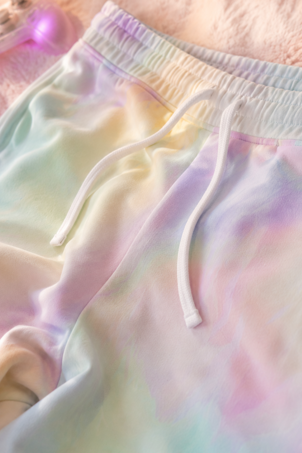 Close-up fabric detail of AFK Mode pastel tie-dye gamer joggers showing soft texture and drawstring waistband.