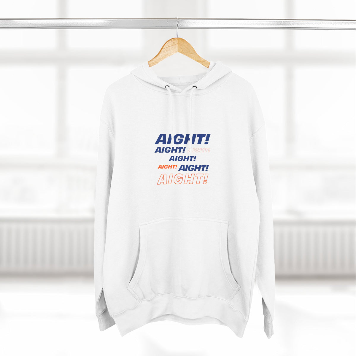 White Aight graphic hoodie hanging in a minimal studio setting