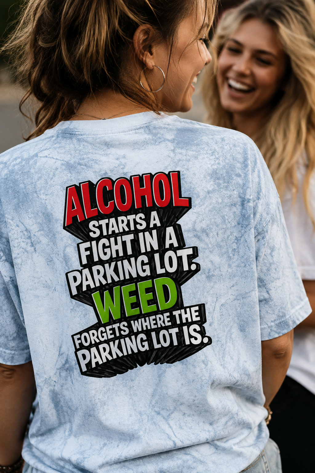 Female Gen Z wearing blue Alcohol vs Weed tie-dye T-shirt, close-up rear view while laughing with a friend