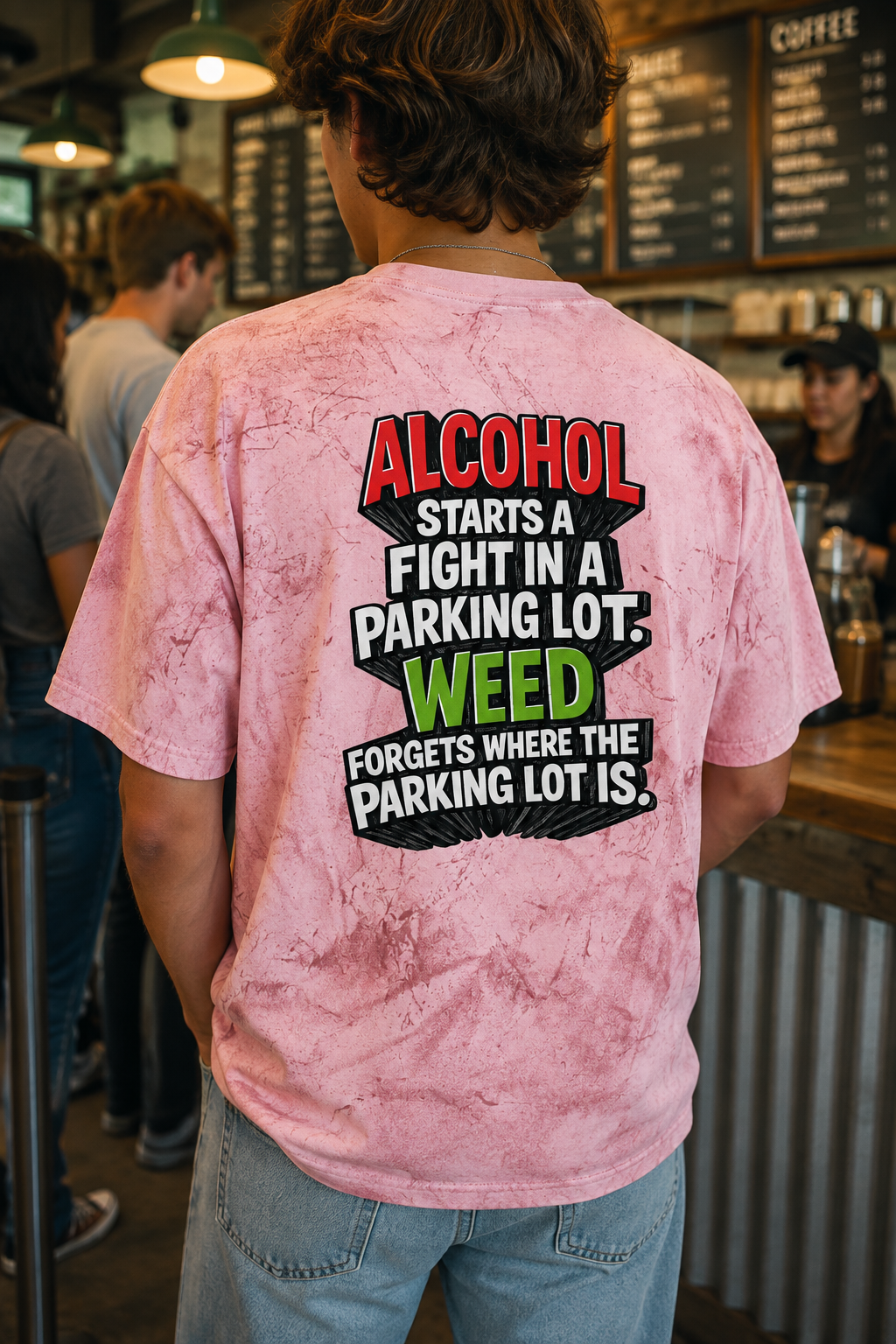 Person wearing pink Alcohol vs Weed tie-dye graphic T-shirt rear view at a coffee shop
