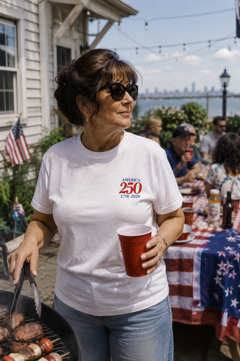 Woman wearing America 250 patriotic t-shirt at family Fourth of July cookout