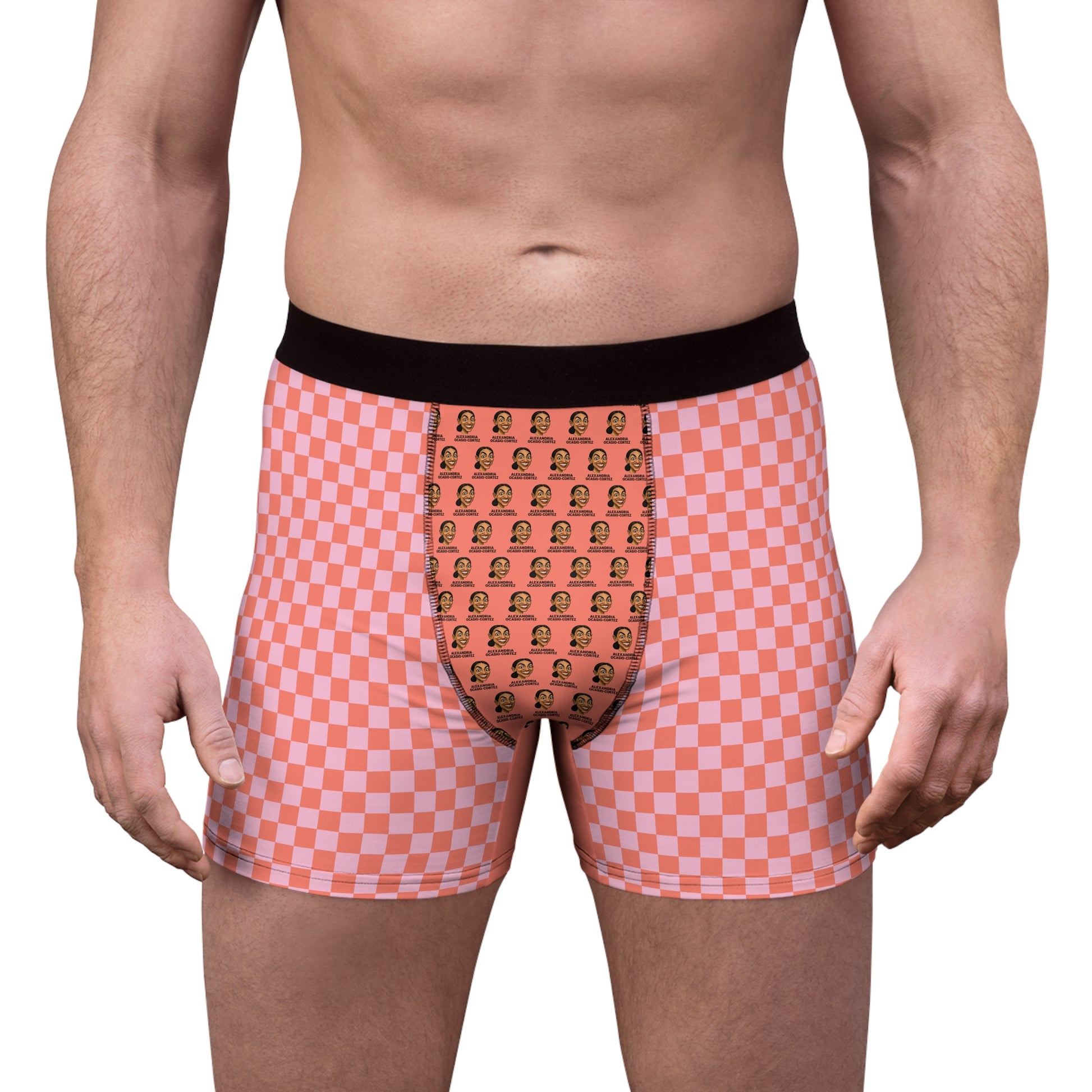 Front on-model view of Tantrum Media AOC boxer briefs featuring a pink checkered pattern, black waistband, and pop art graphic print.
