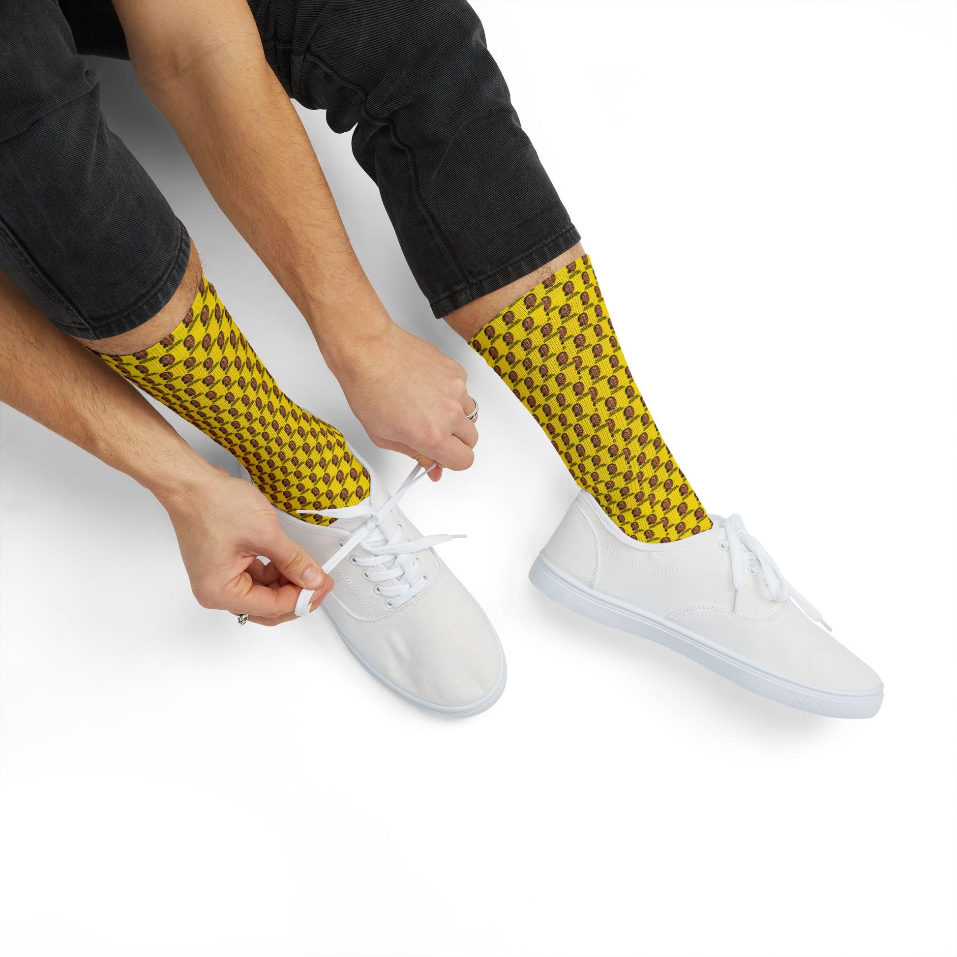 Close-up of a person pulling on yellow AOC crew socks featuring repeating Alexandria Ocasio-Cortez artwork before putting on sneakers.