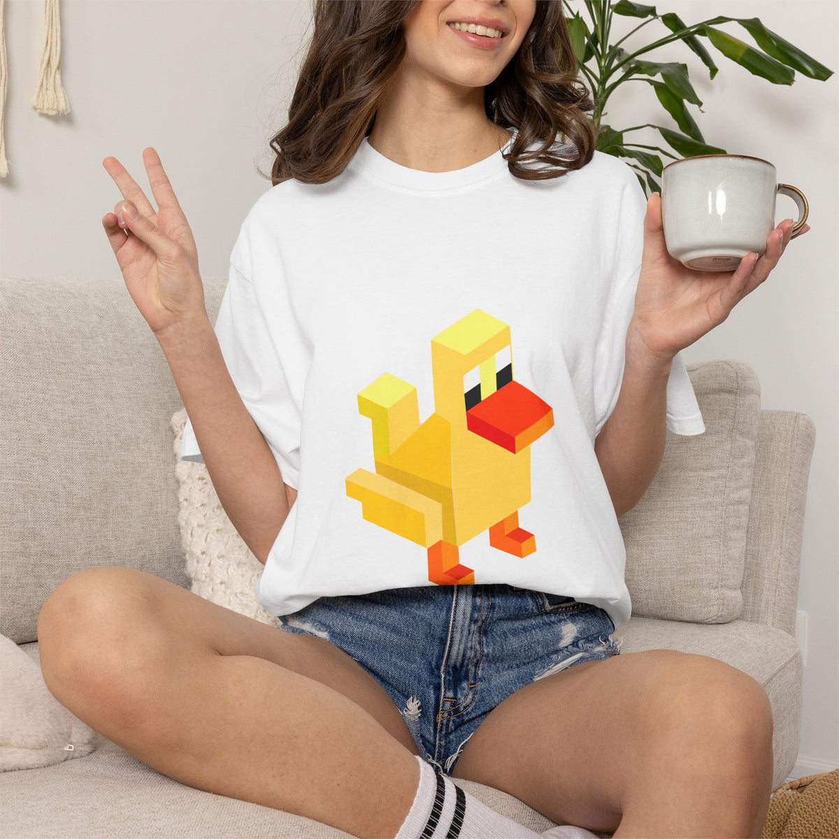 Woman wearing white Arcade Duck retro pixel gaming T-shirt with yellow duck graphic