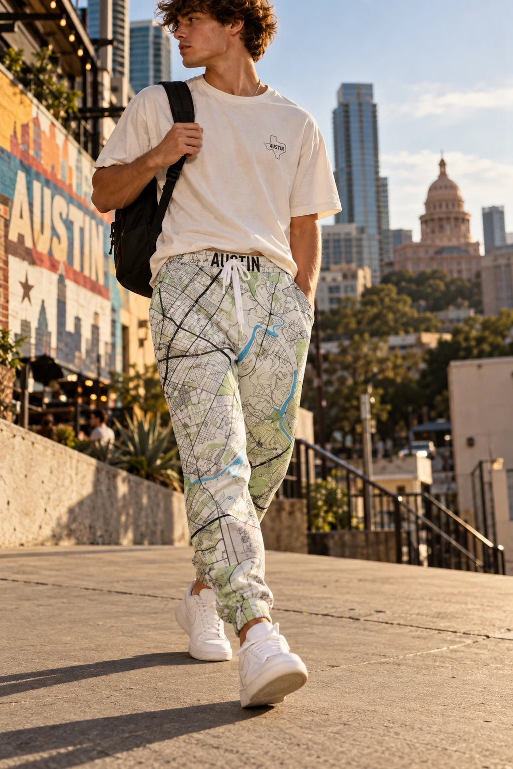 Young man wearing Austin Texas map joggers in downtown Austin