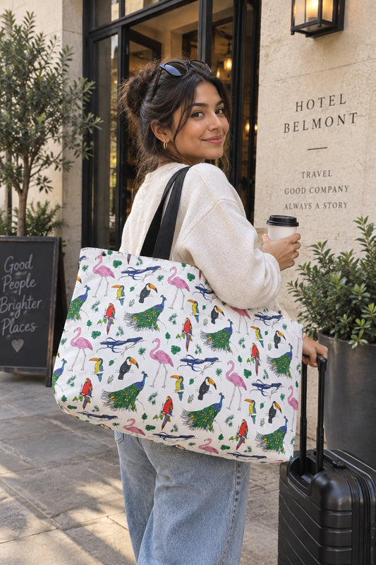 Avian bird print weekender bag carried by traveler outside a hotel
