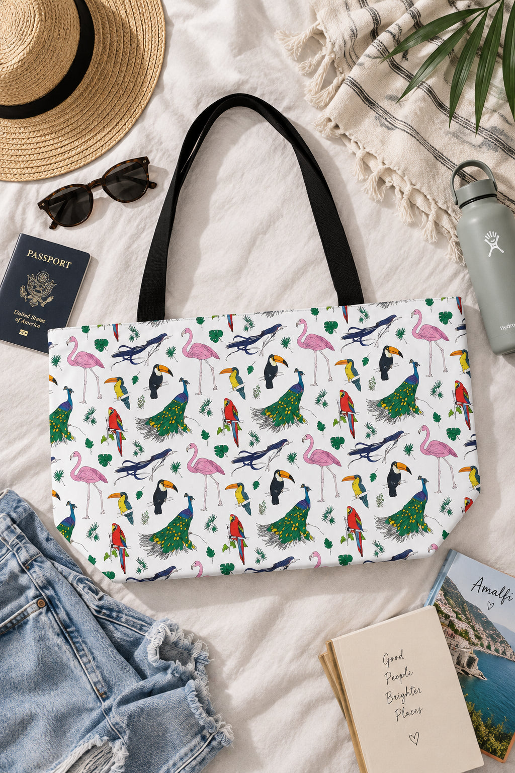 Avian bird print weekender bag flat lay with hat sunglasses and travel accessories