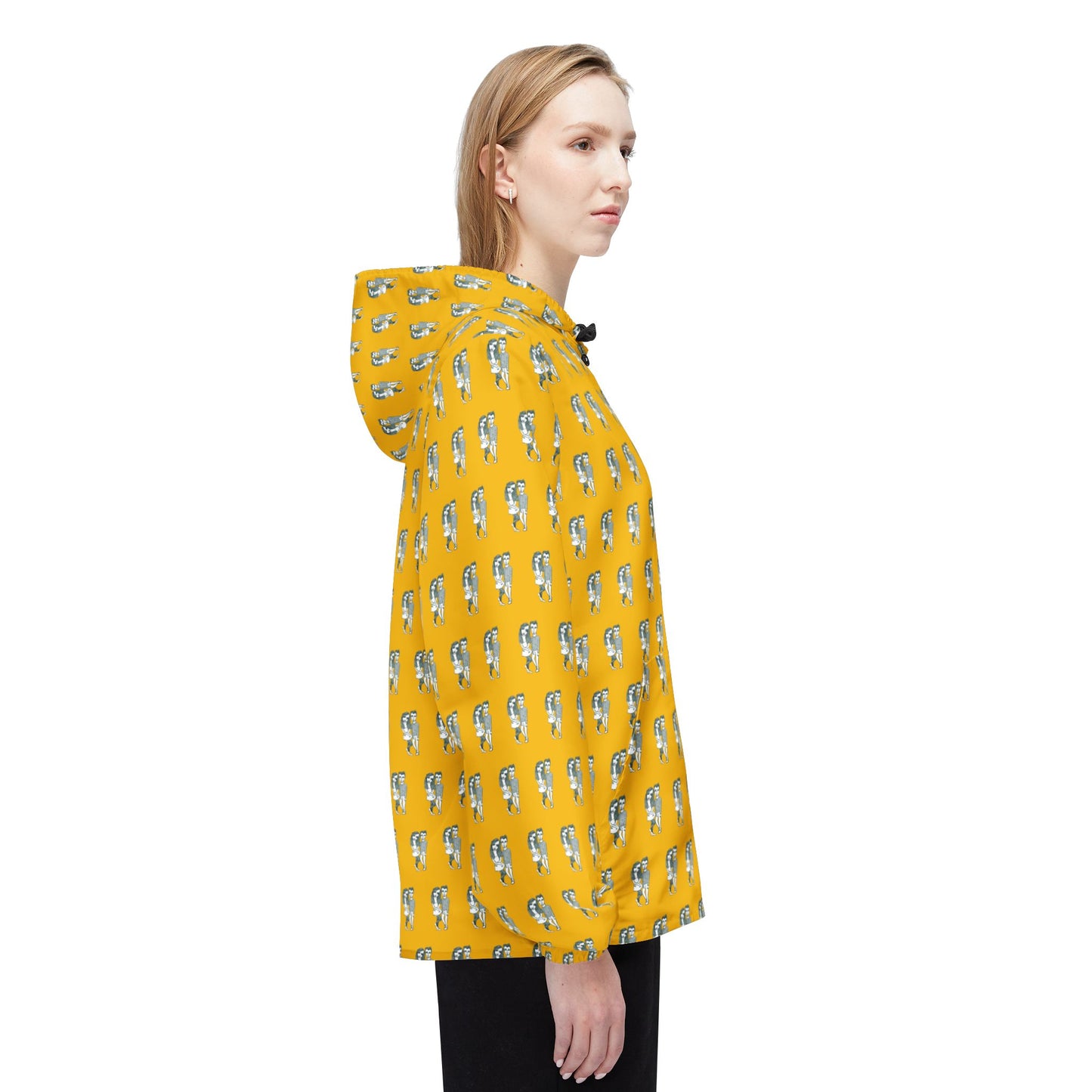 Side view of woman wearing yellow Babes windbreaker jacket with illustrated print