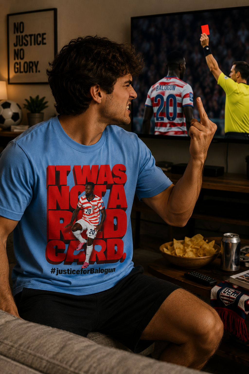 male model wearing blue It Was Not a Red Card soccer graphic t-shirt while watching USA game on TV