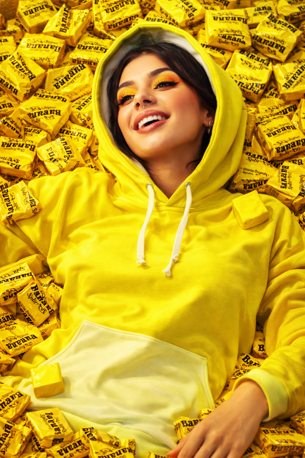banana yellow hoodie creative aesthetic streetwear model wearing bold color pop pullover surrounded by banana candy