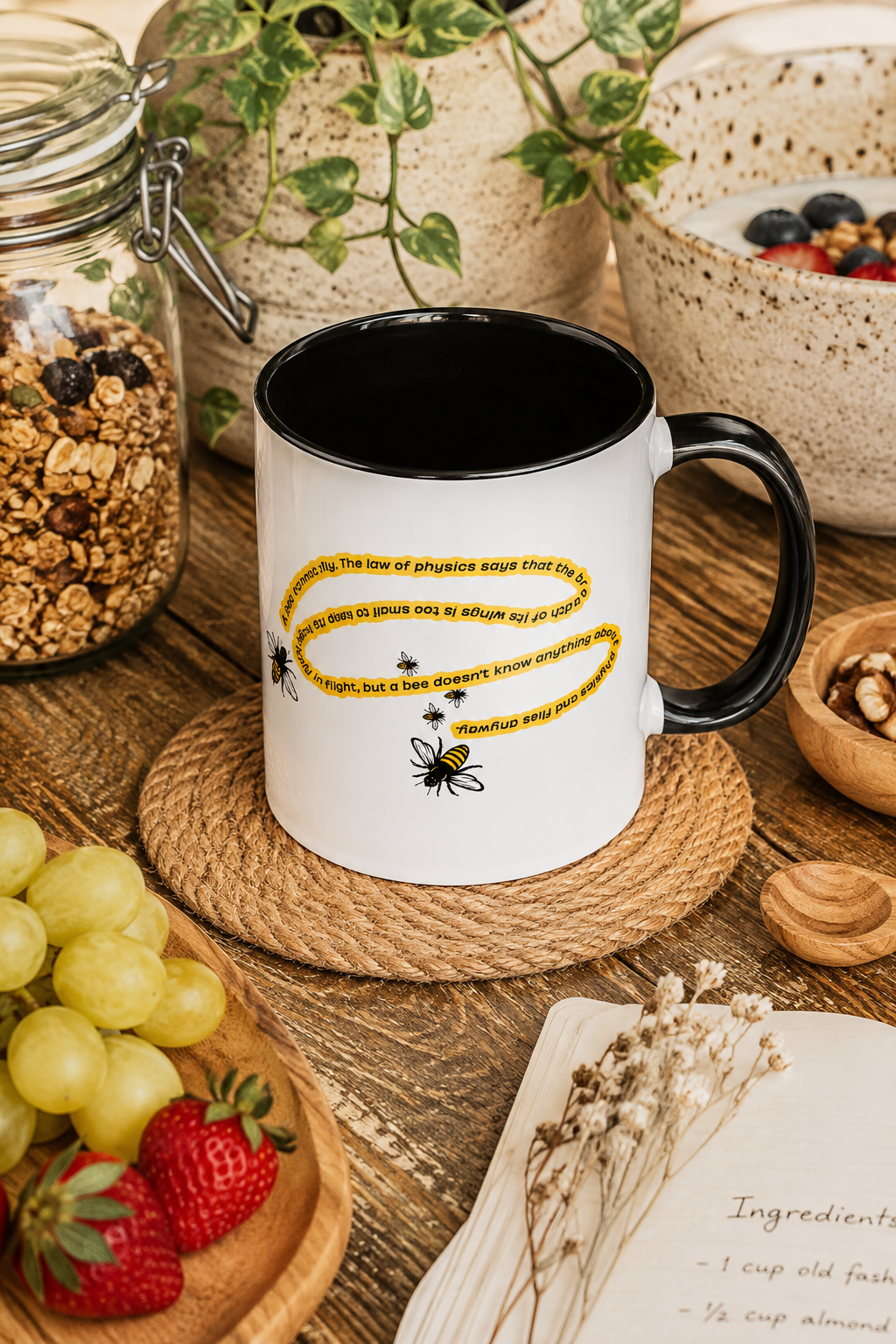 Black accent bee coffee mug in an artisanal kitchen with granola and fruit