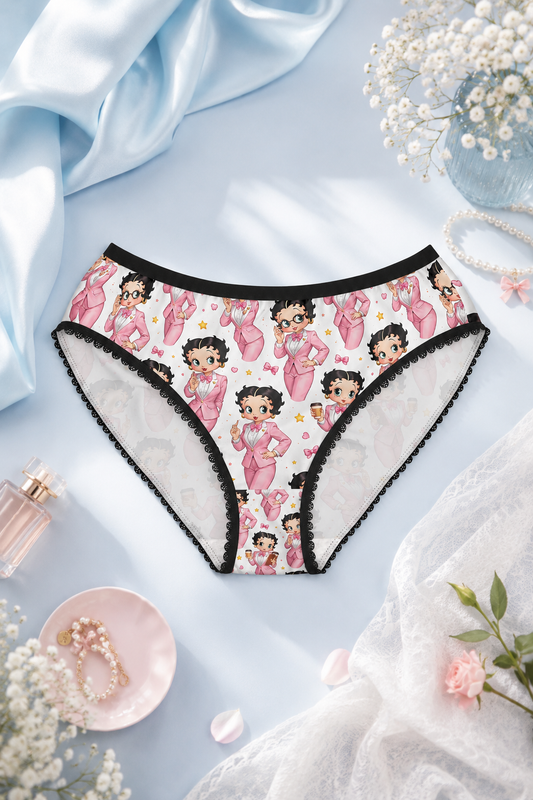 Betty Boop women’s briefs with pink suit character print and black lace trim in a pastel blue flat lay