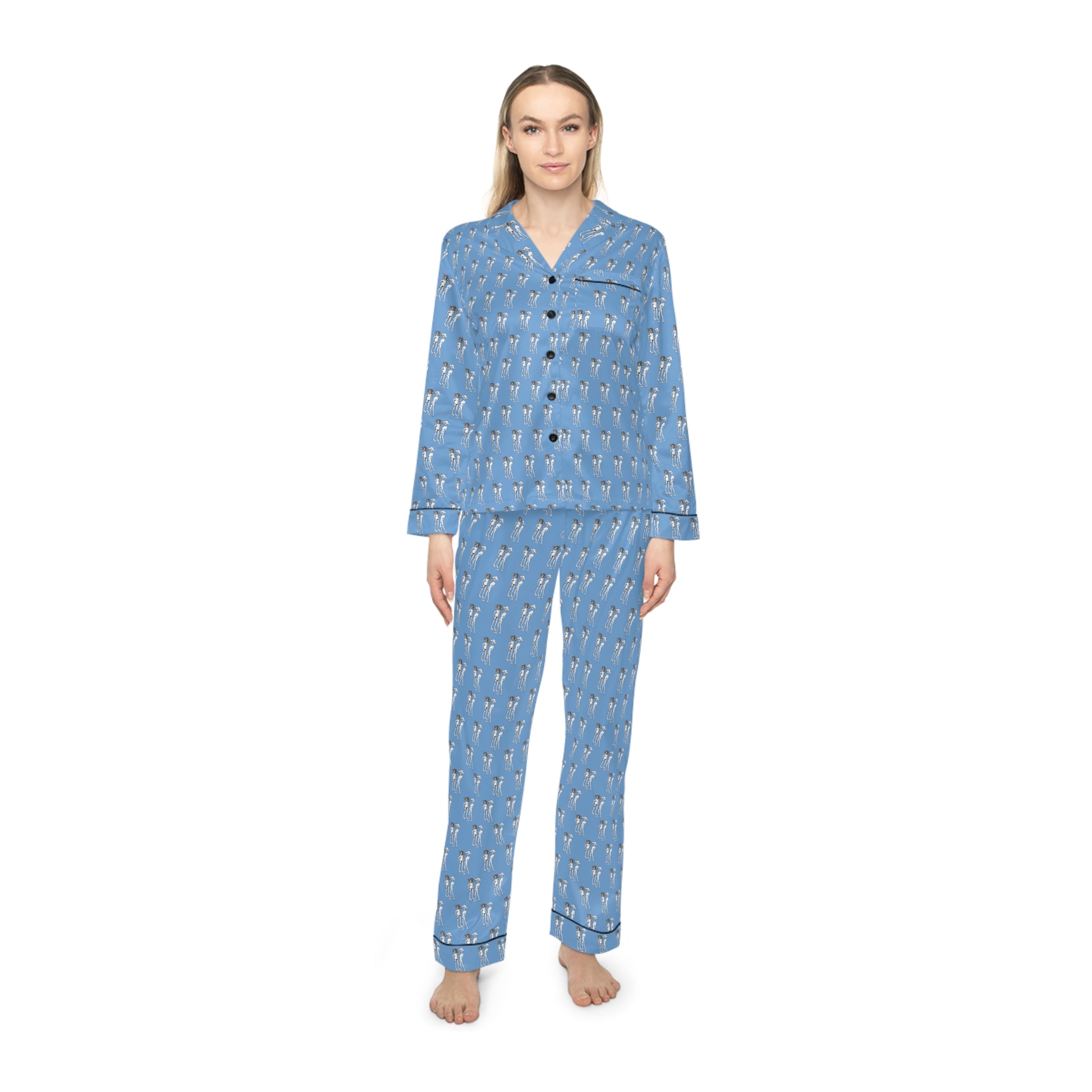 Female model wearing Bikini Nenas women's satin pajama set in blue with original artist-designed print and relaxed fit.