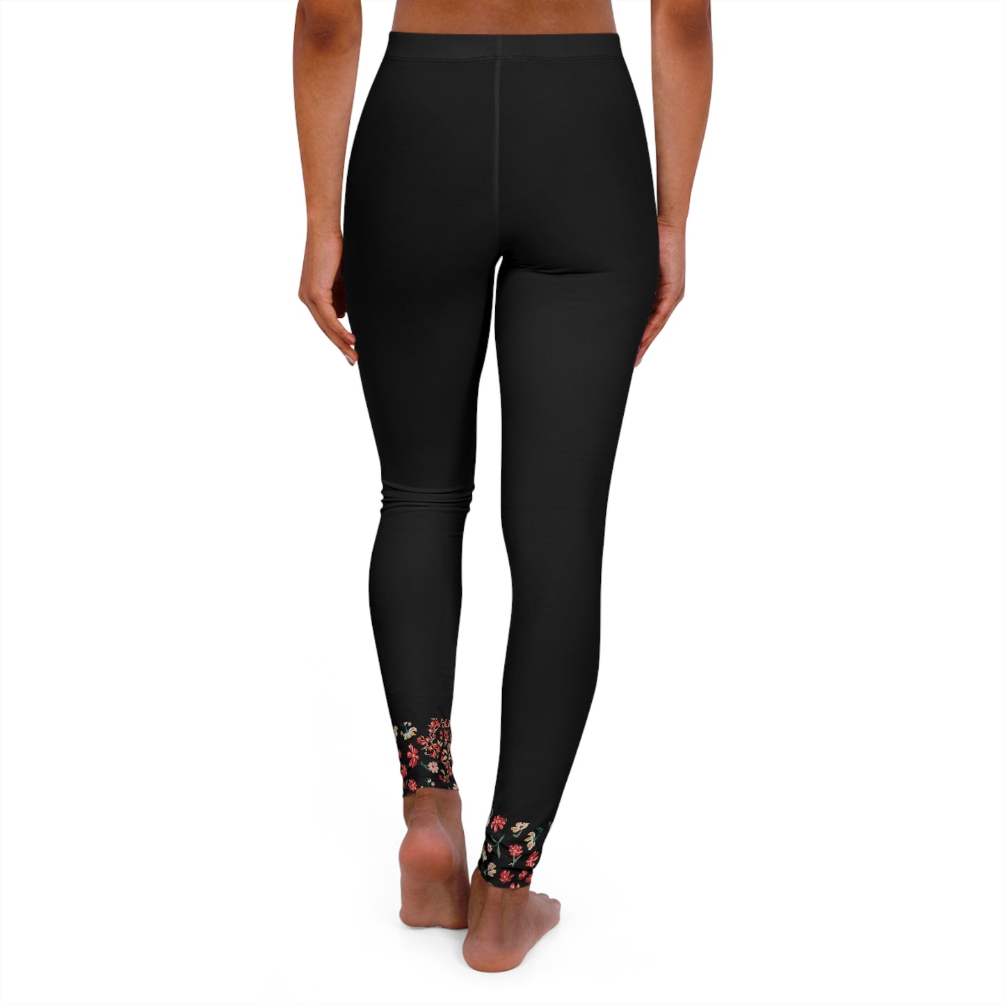 Back view of black leggings with floral ankle detail.