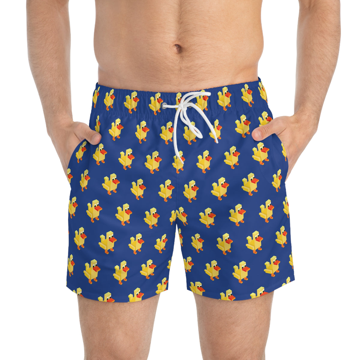 Male model wearing blue 8-bit duck swim trunks standing poolside in sunlight