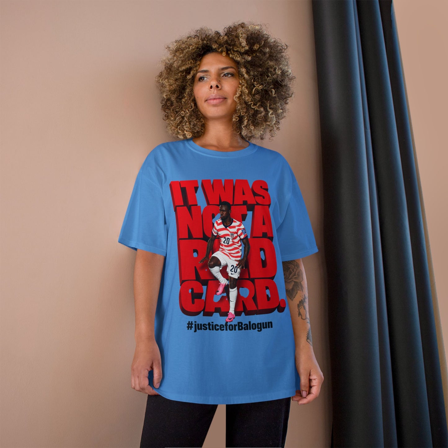 female model wearing blue Balogun soccer protest graphic t-shirt