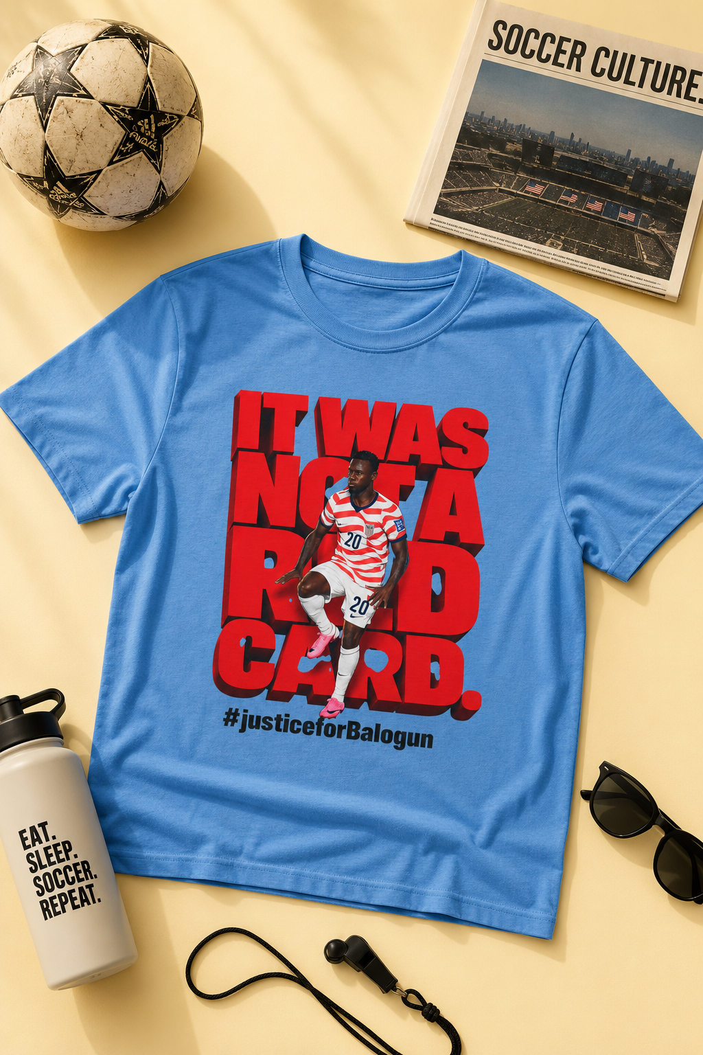 blue It Was Not a Red Card Balogun soccer graphic t-shirt flat lay mockup