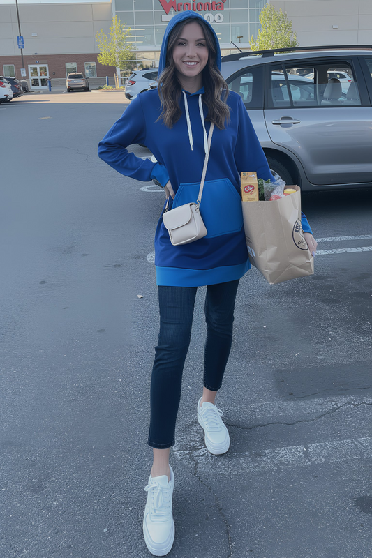 Woman wearing blue color block hoodie dress while shopping