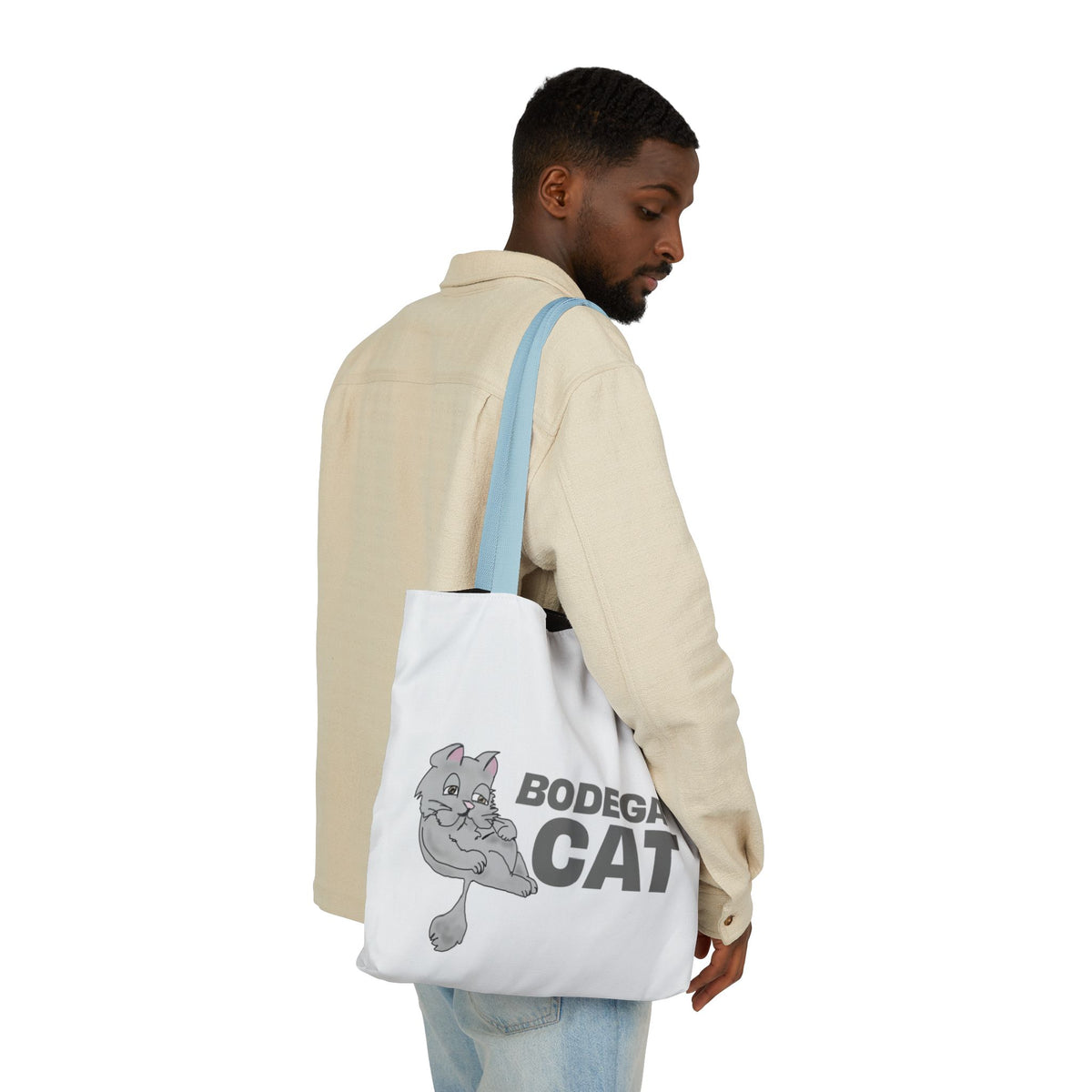 Bodega Cat white tote bag with blue straps carried by male model
