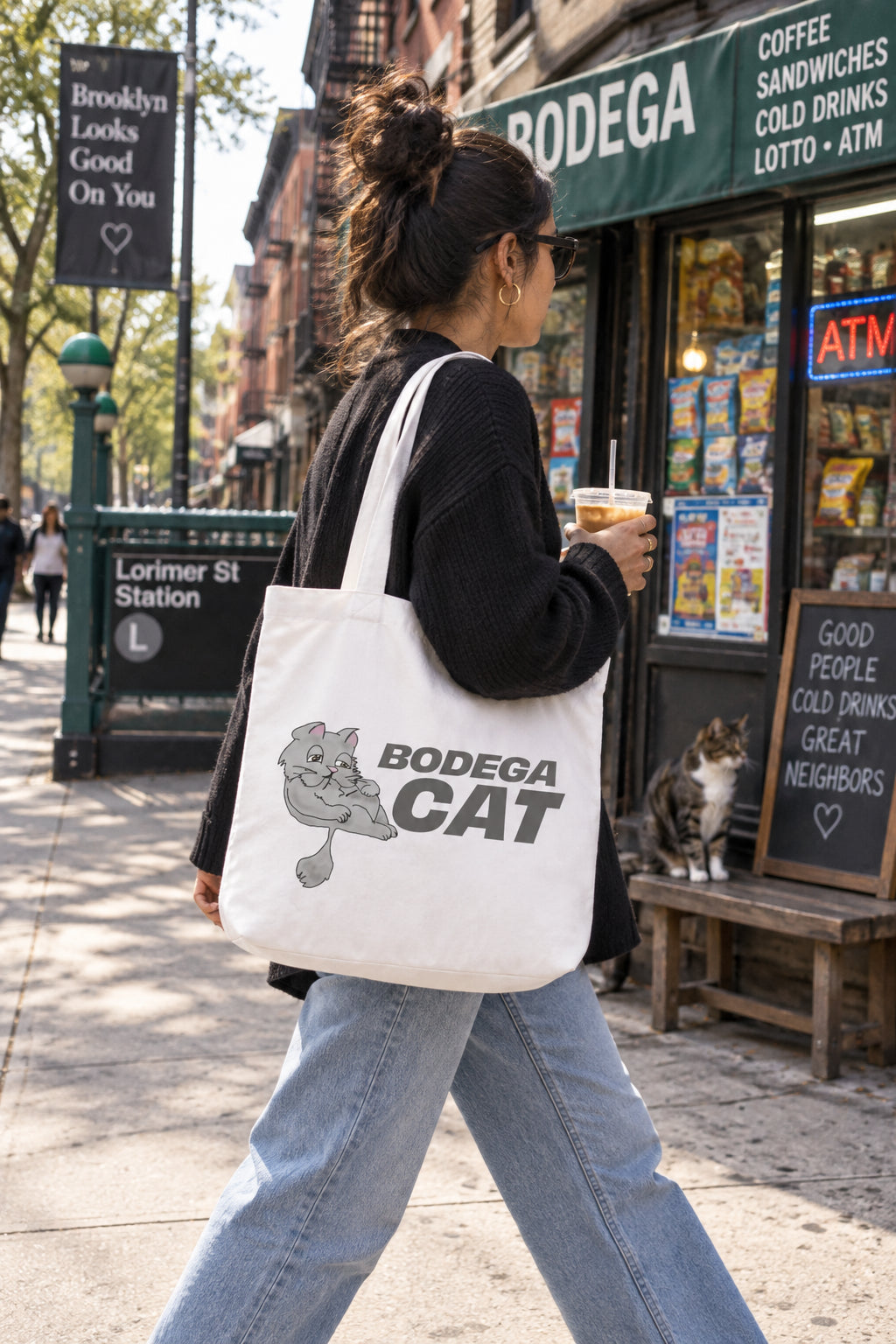 Bodega Cat white tote bag carried outside a New York City bodega