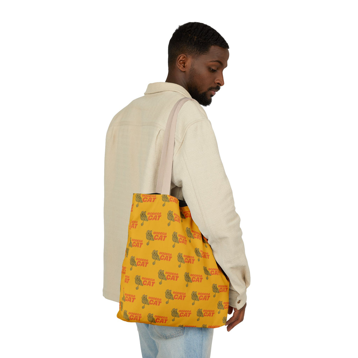 Bodega Cat yellow tote bag carried by male model in casual everyday outfit