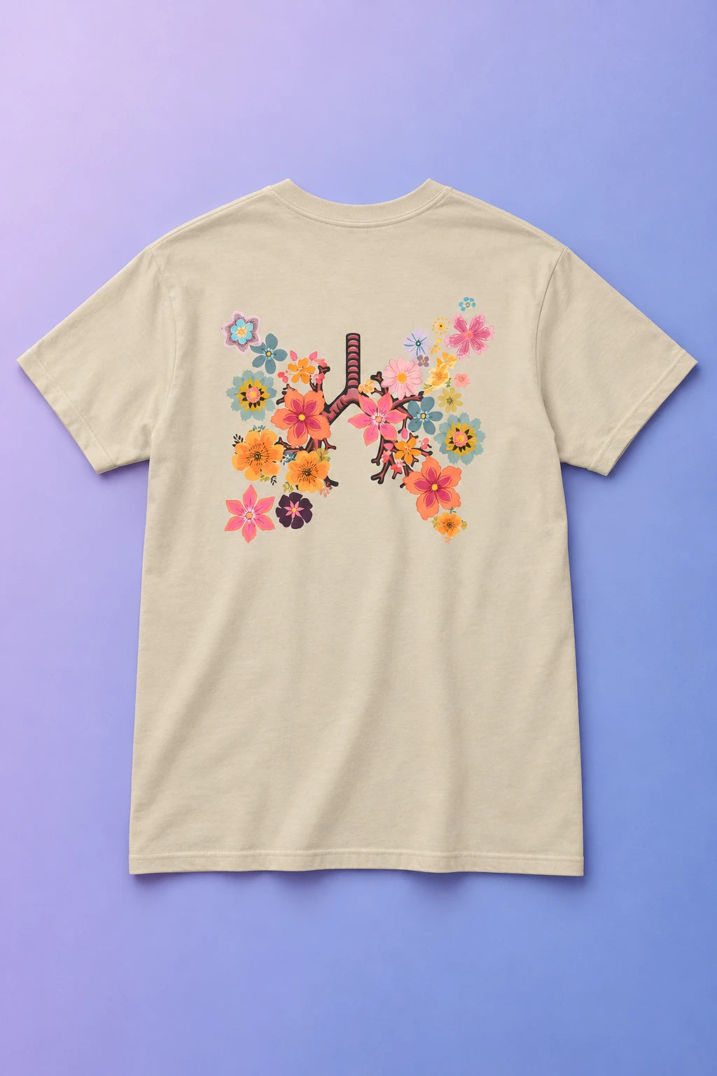 Sand Breath T-shirt laid back-side up on a lavender gradient, showing its colorful floral lungs print.