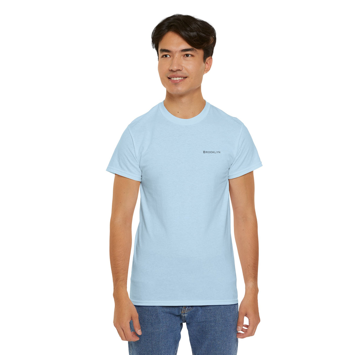Man wearing a light blue Brooklyn crewneck T-shirt with blue jeans.