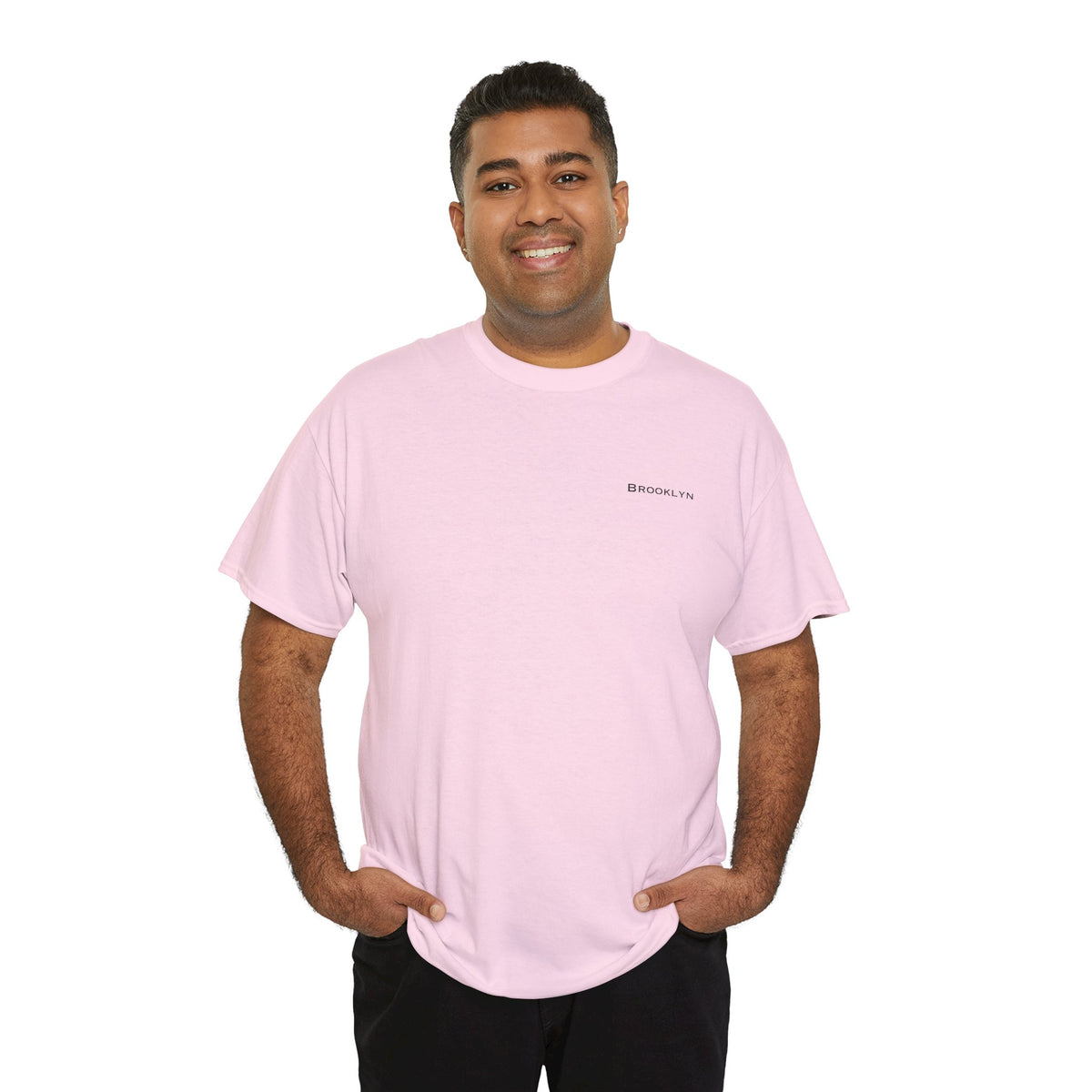 Man wearing a pink Brooklyn unisex T-shirt with small black left-chest lettering.