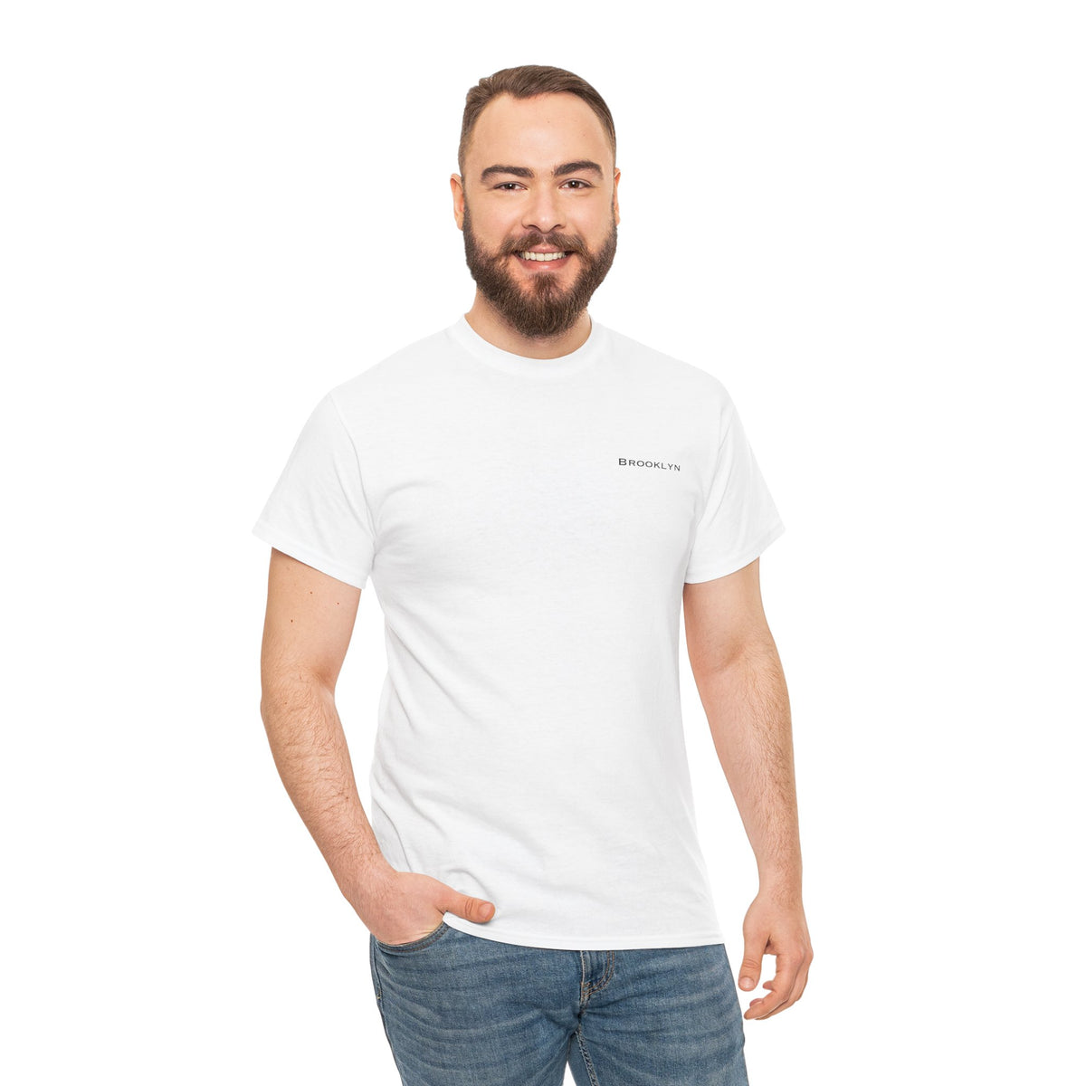 Man wearing a white Brooklyn crewneck T-shirt with blue jeans.
