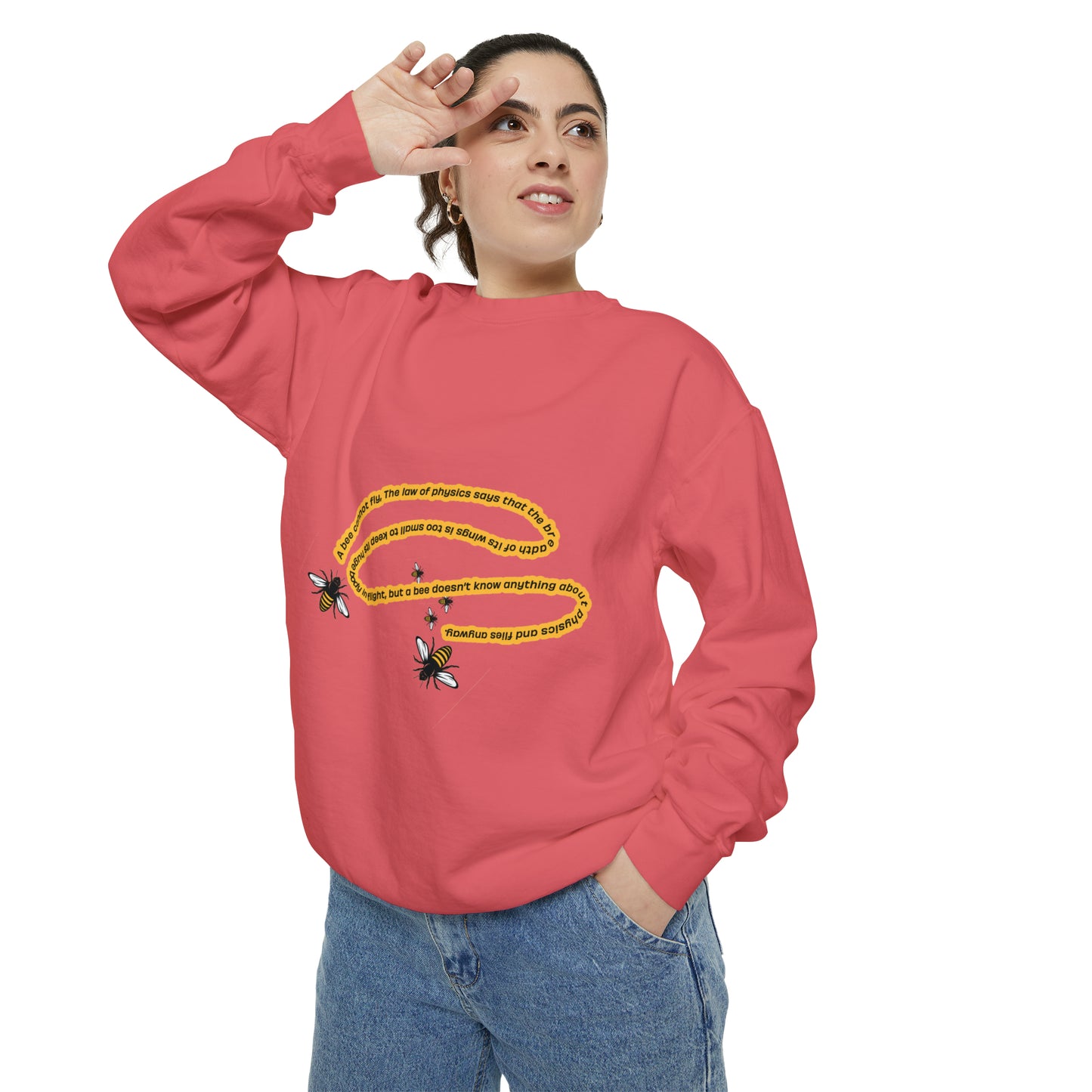 Woman modeling a coral bumblebee graphic sweatshirt with relaxed fit and blue jeans.