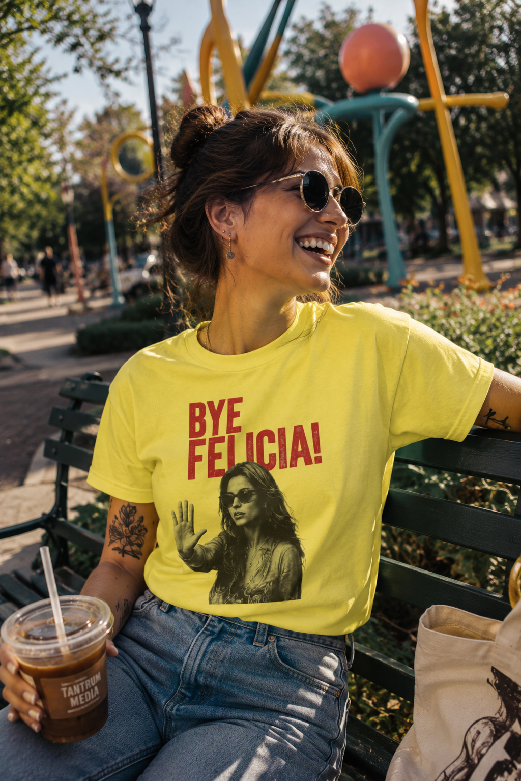 Female millennial wearing yellow Bye Felicia graphic t-shirt in park mockup