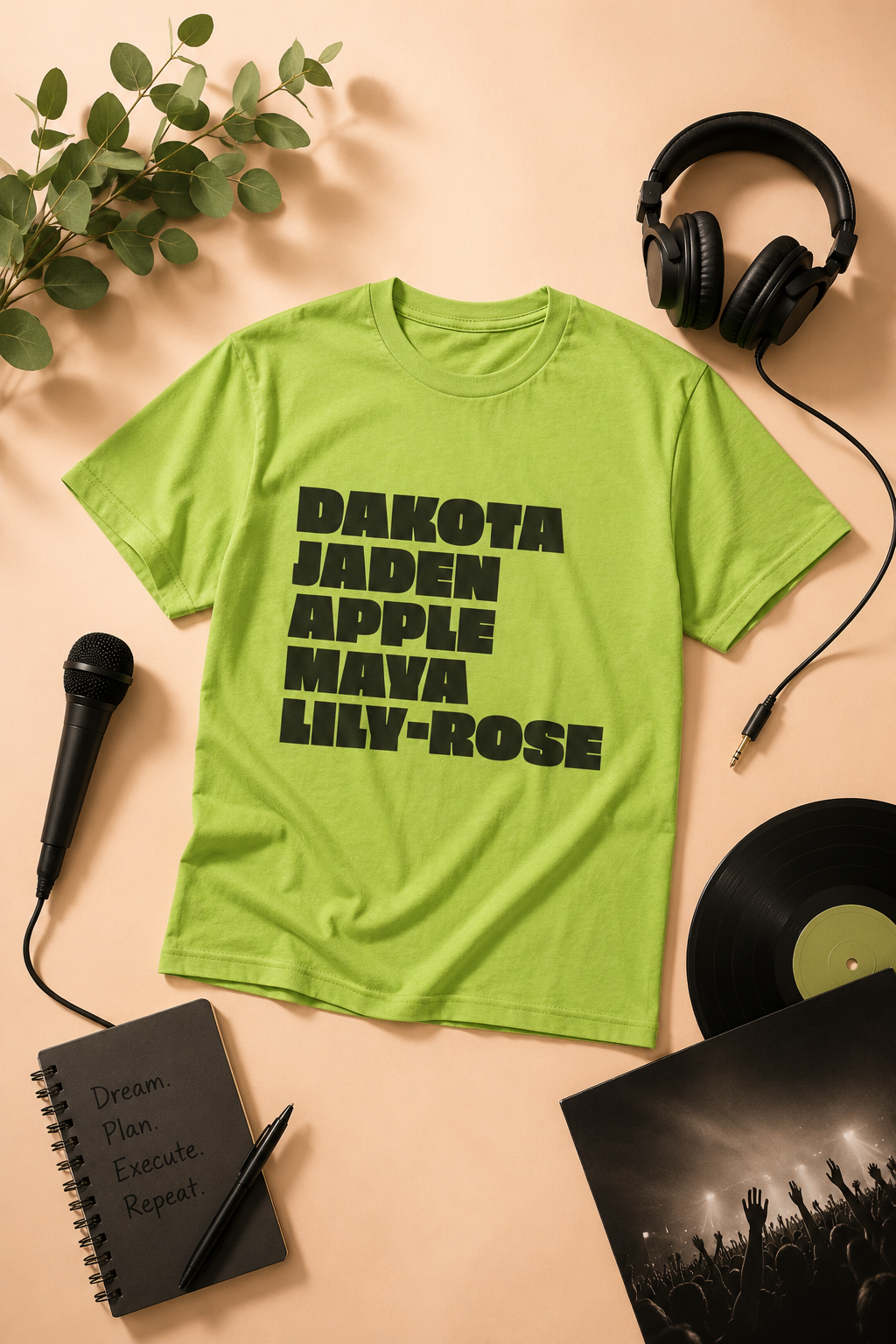 nepo babies names list graphic t-shirt displayed in an entertainment-inspired editorial flat-lay with headphones, microphone, vinyl record, and creative studio accessories on a soft peach background 