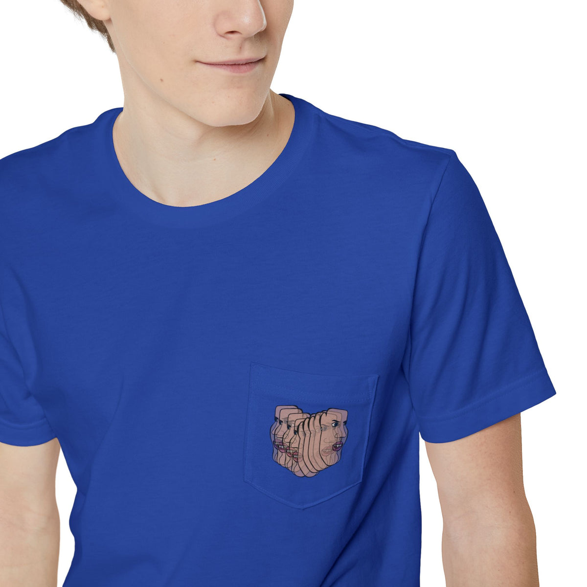 Close-up of the Charlie Deluxe abstract face graphic pocket on a blue T-shirt