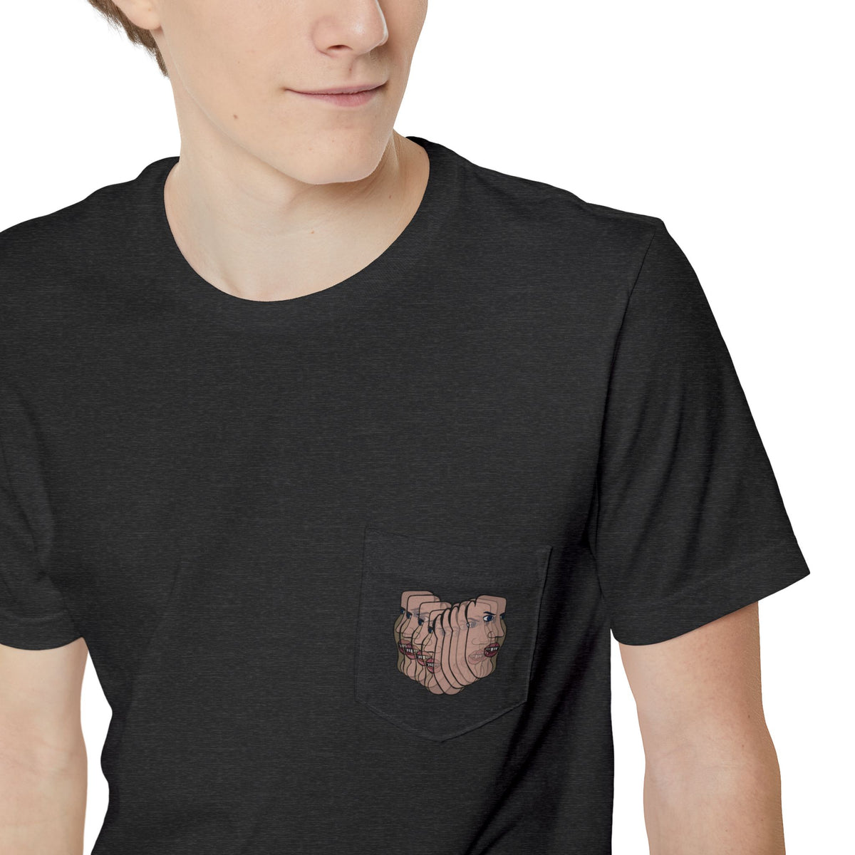 Close-up of the Charlie Deluxe abstract face graphic pocket on a charcoal gray T-shirt