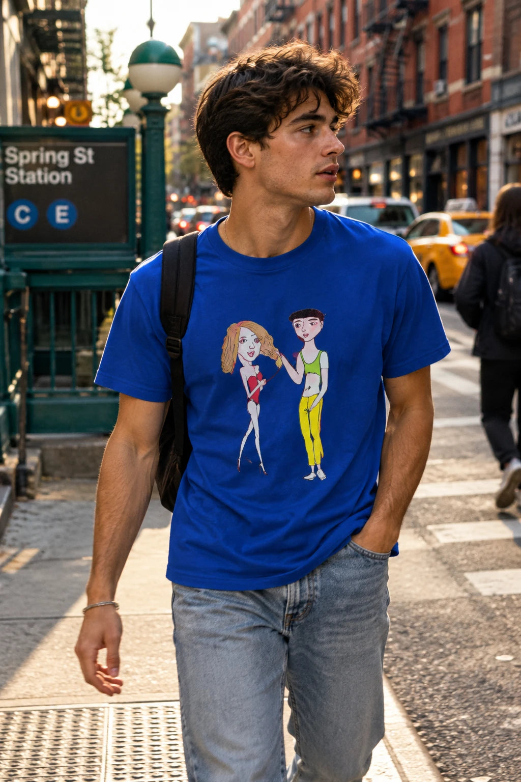 Man wearing blue Charlotte & Van graphic T-shirt on a New York City street