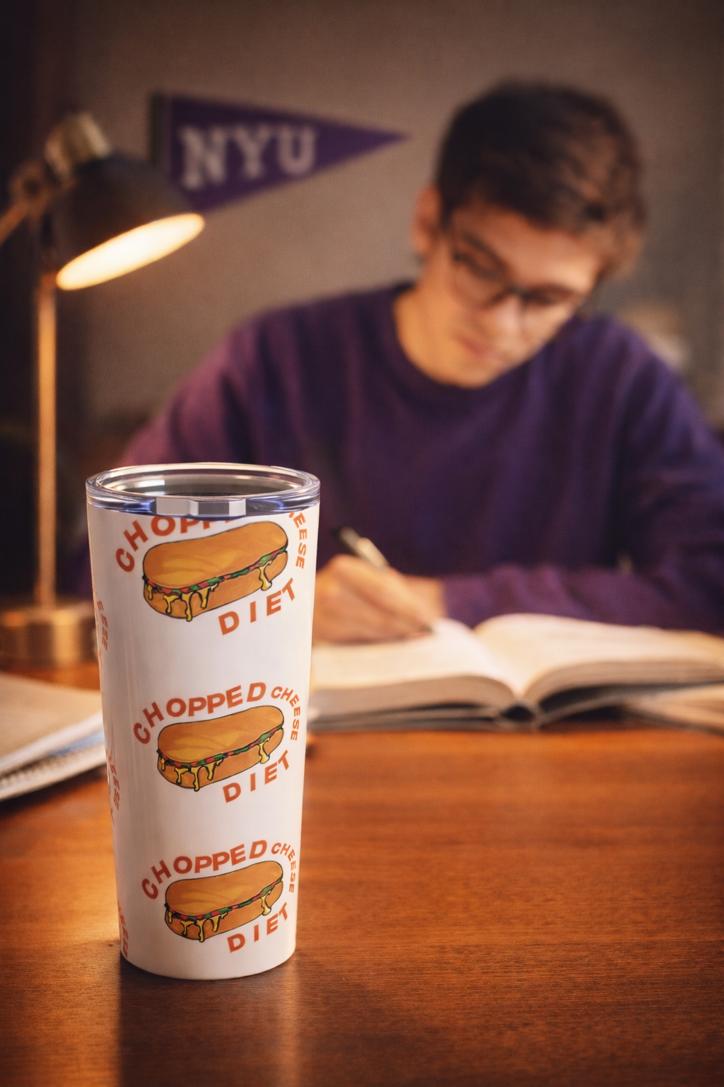 Chopped Cheese Tumbler 20oz stainless steel travel cup with NYC deli sandwich design on desk during study session