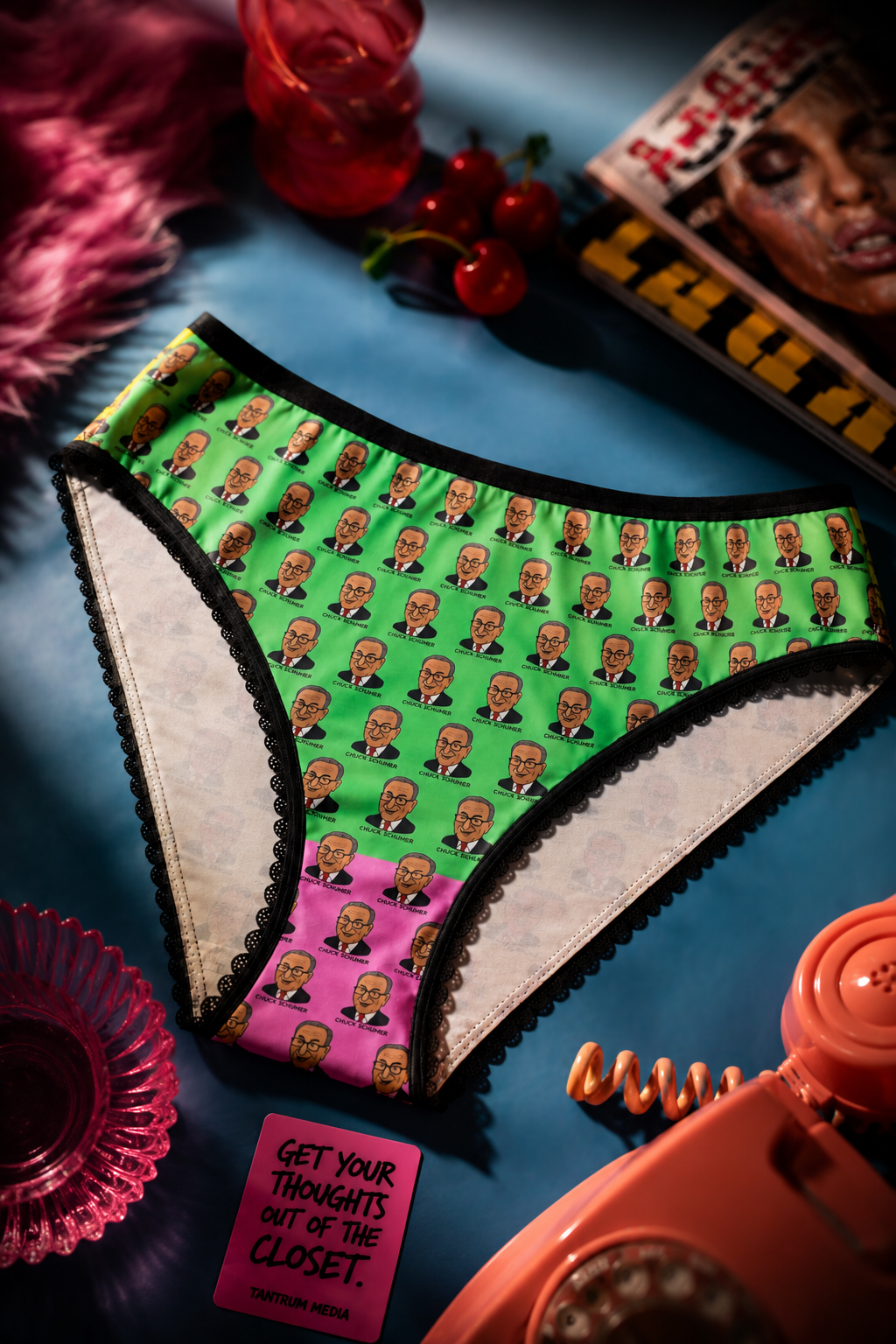 Editorial flat lay of colorful Chuck Schumer novelty women's panties with vibrant political satire artwork.