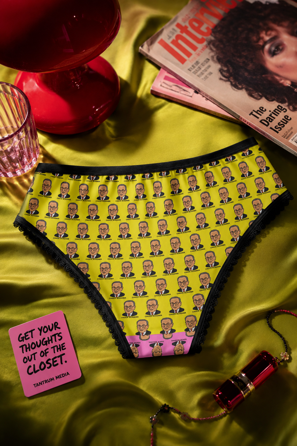 Editorial flat lay of Chuck Schumer novelty women's panties showcasing colorful political satire artwork and premium fabric.