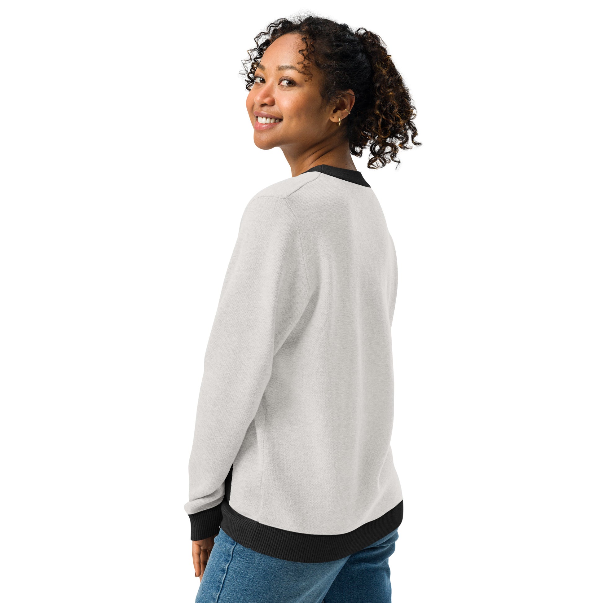 Side view of the sweater on a model showing sleeve shape and relaxed fit.
