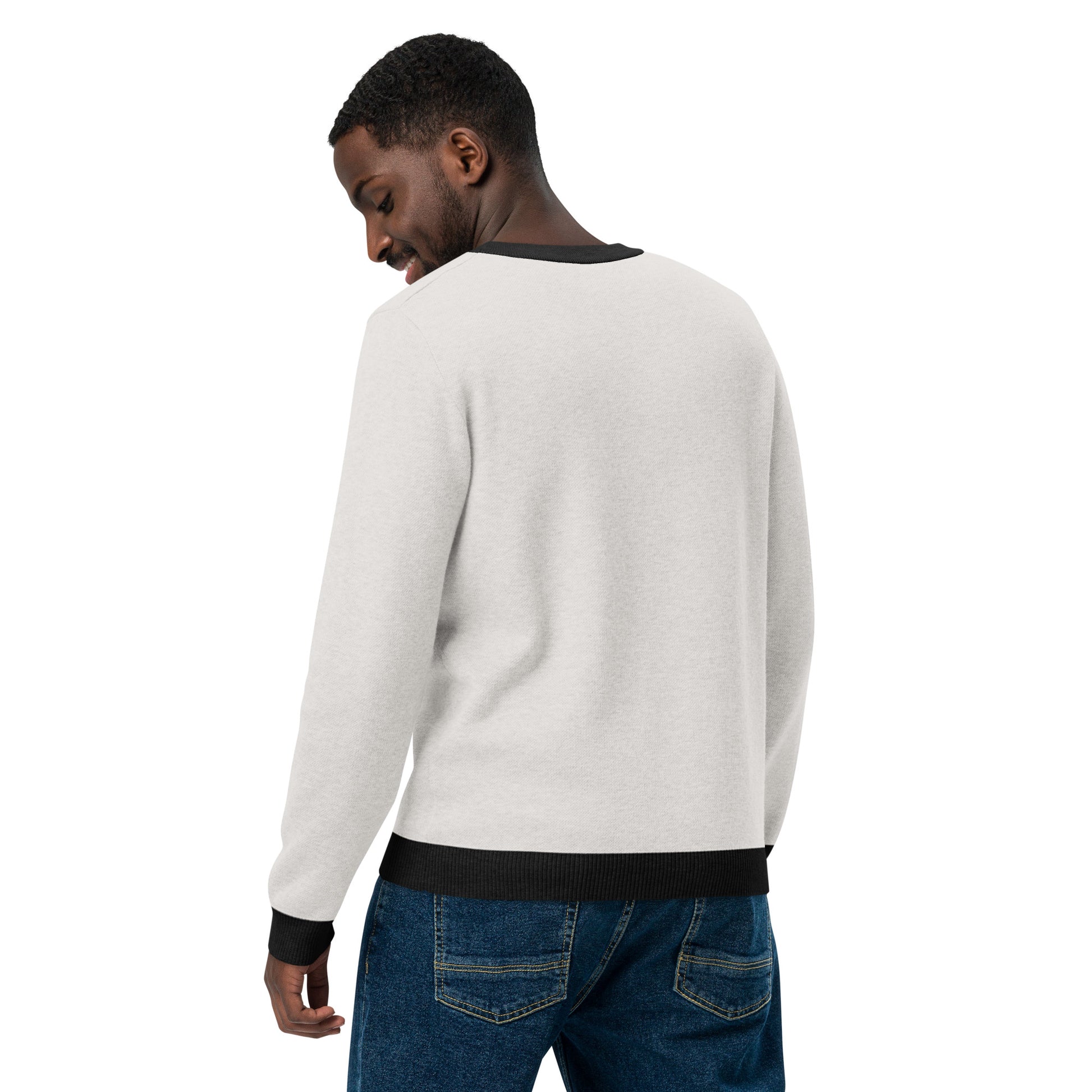 Side view of a person wearing the light sweater showing solid back and black trim