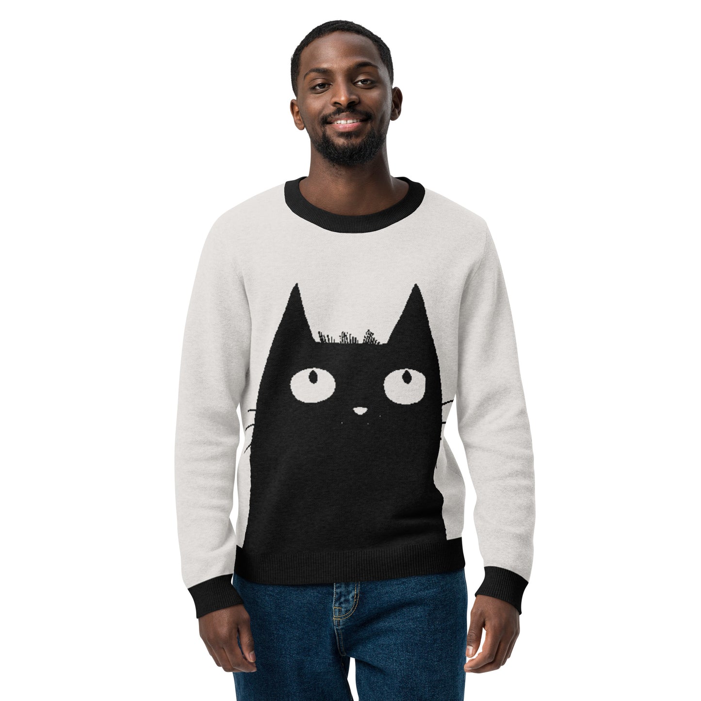 Product Studio image of a person wearing the cat graphic sweater, standing and smiling.