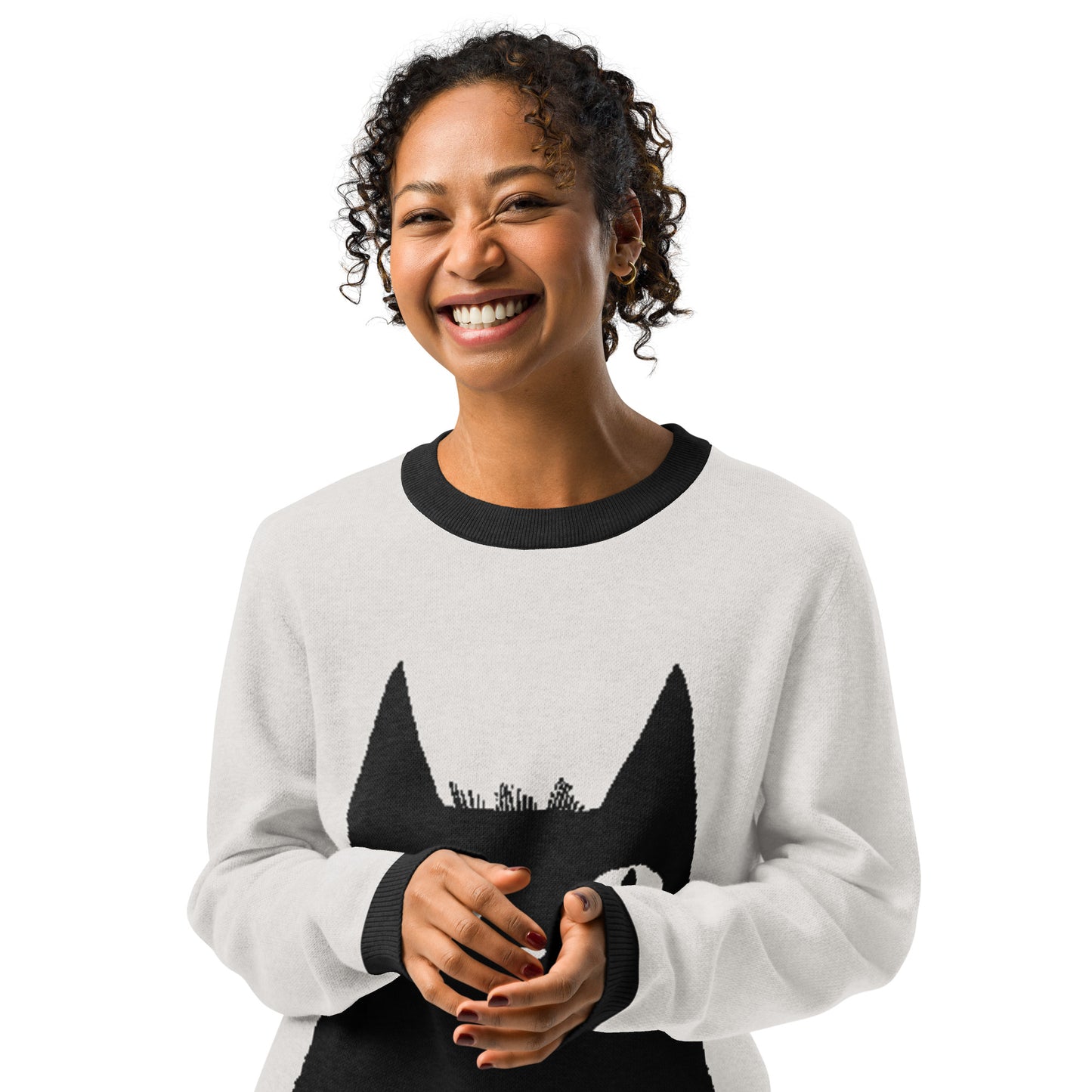 Front view of the person wearing the cat graphic sweater smiling toward the camera.