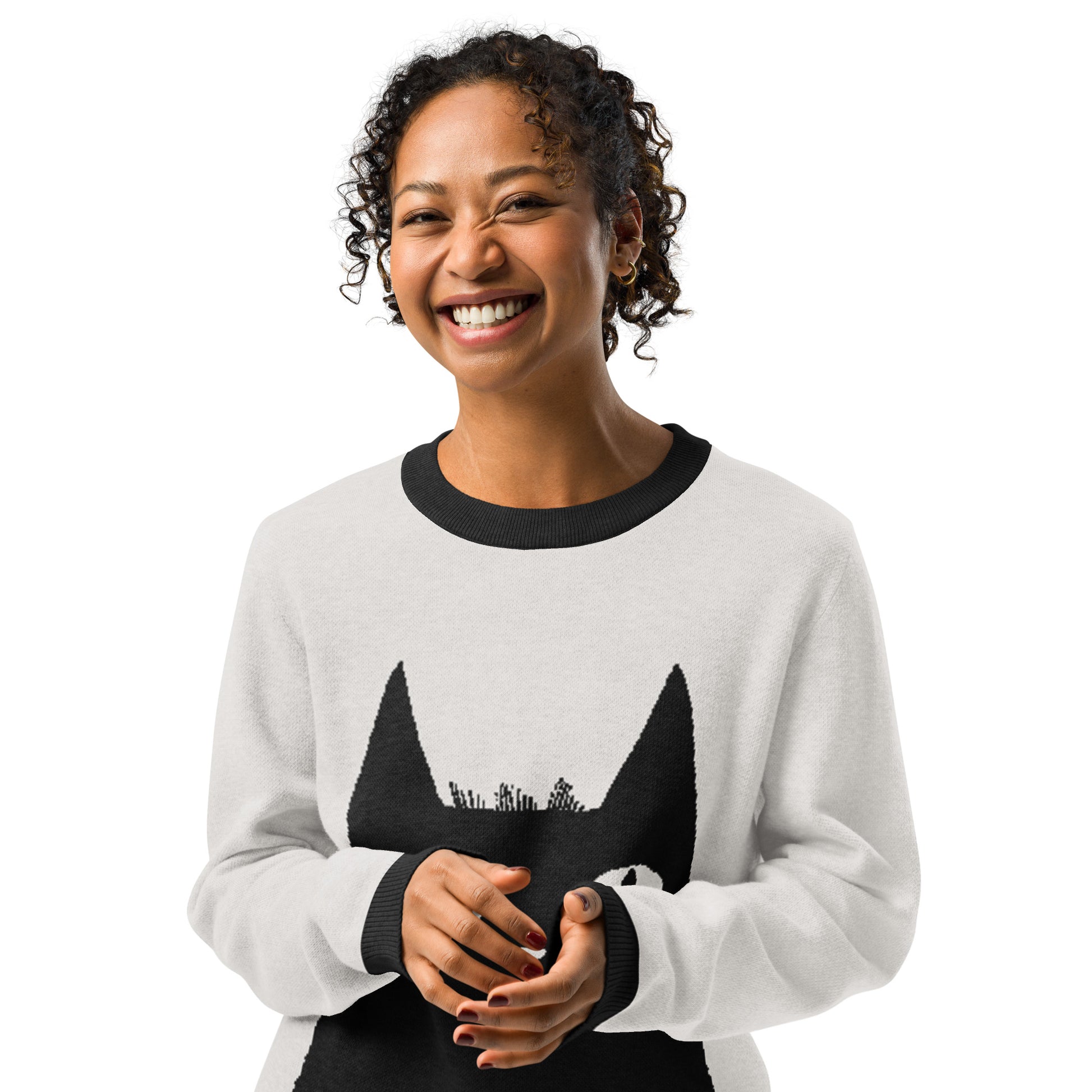 Front view of the person wearing the cat graphic sweater smiling toward the camera.