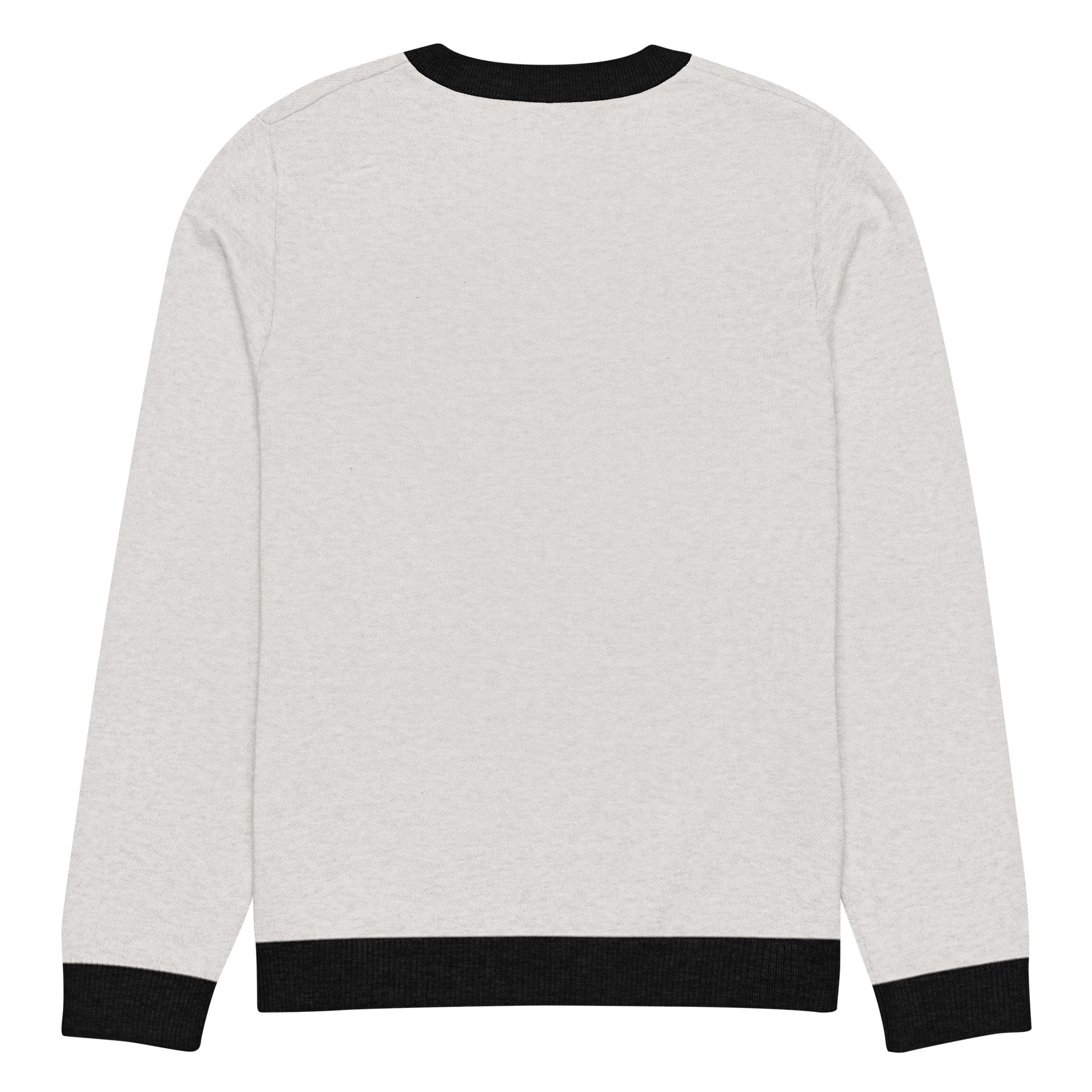 Flat back view of the light sweater showing solid color and black cuffs and hem.