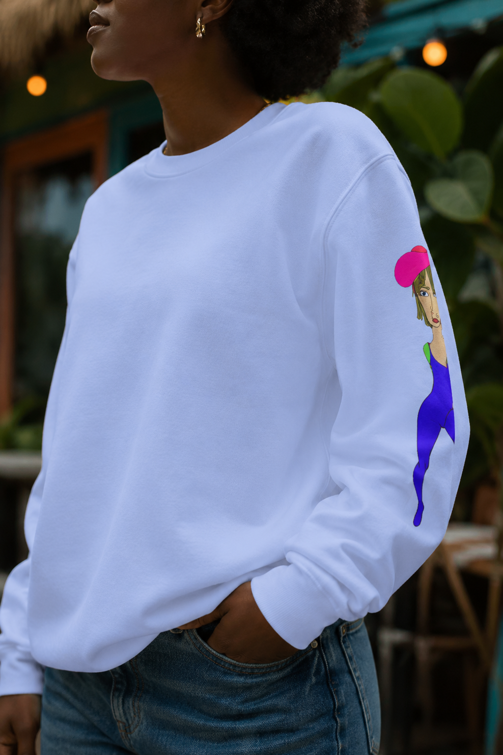 Close up detail of light blue Cody graphic unisex crewneck sweatshirt showing sleeve illustration