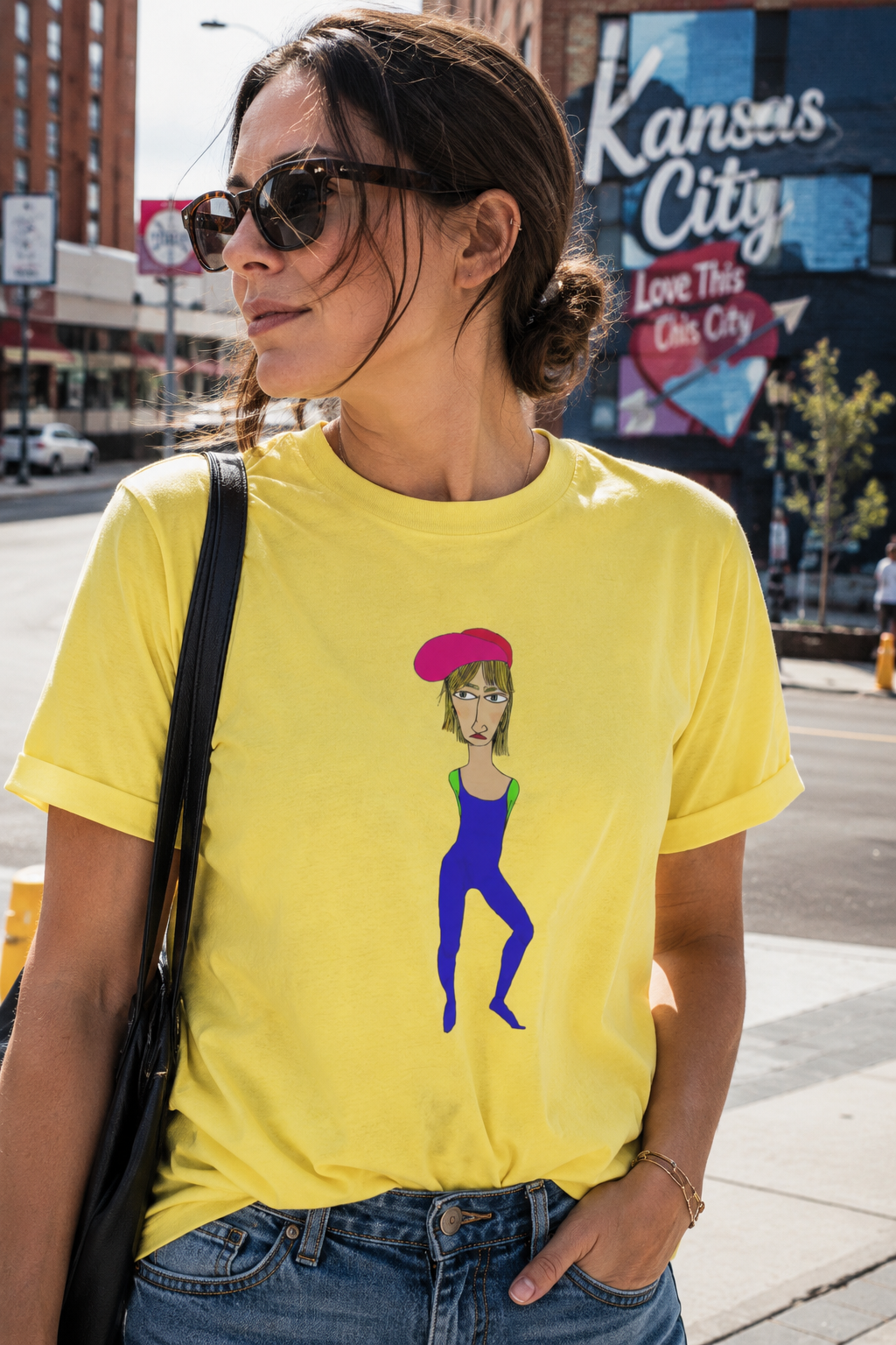 Cody graphic unisex t-shirt in yellow worn by woman outdoors