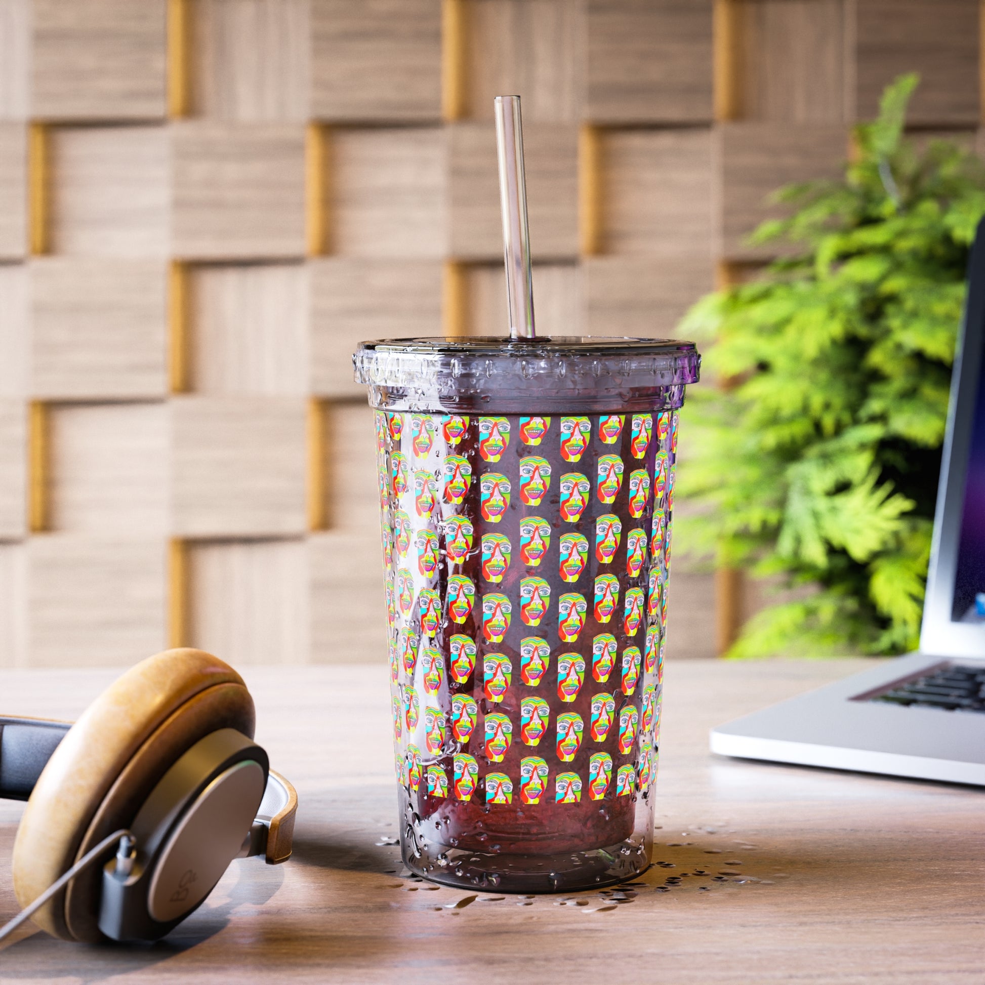Colorfest insulated acrylic tumbler with straw beside laptop and headphones on a modern desk