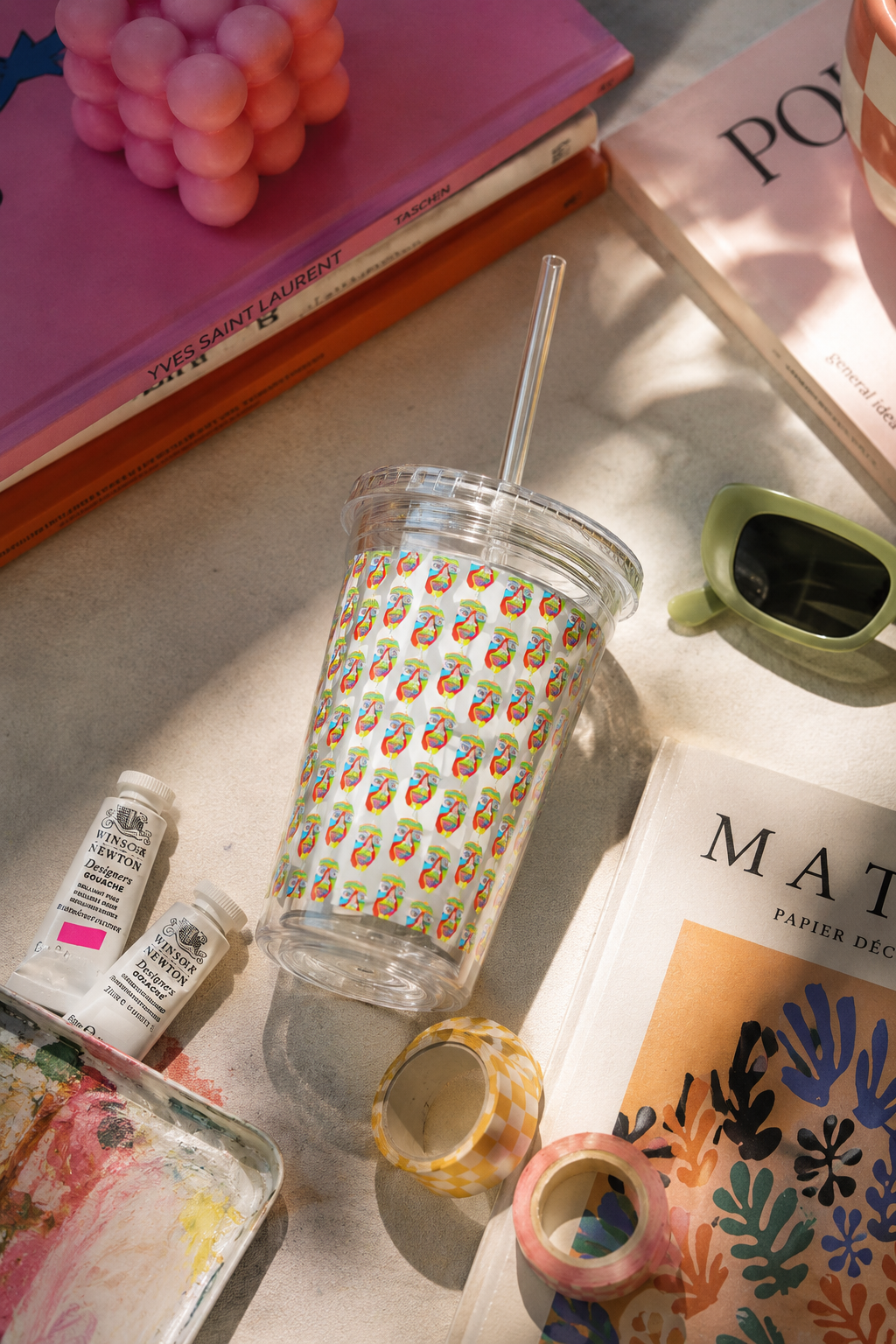 Colorfest patterned acrylic tumbler with straw in an artistic flat lay featuring colorful desk accessories