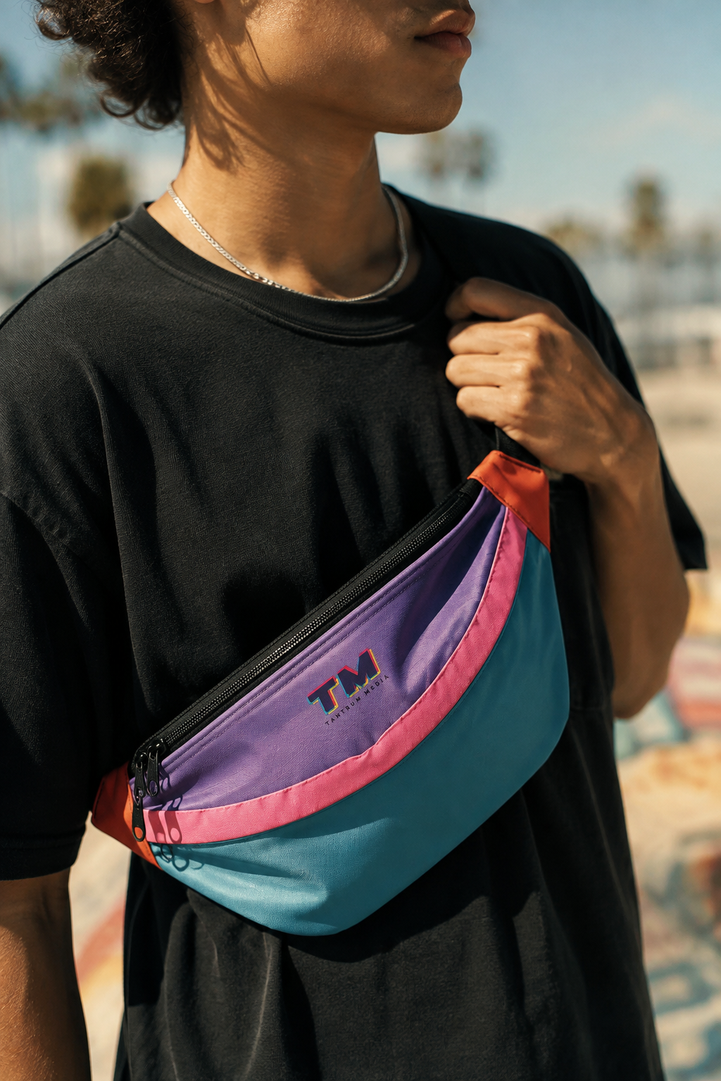 Gen Z man wearing a colorful multicolor fanny pack as a crossbody waist bag outdoors.